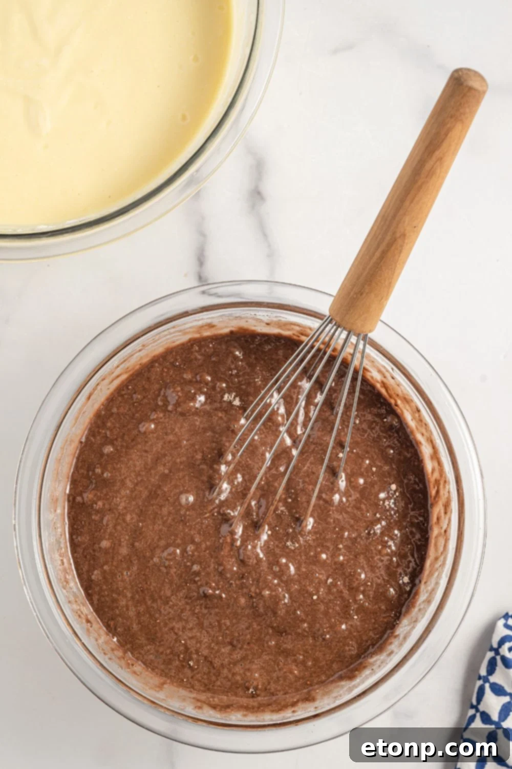 Dolce Vita Cake 9 chocolate cake mix being prepared in a glass bowl with a whisk