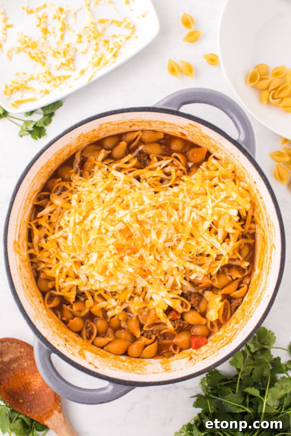 Cheesy Taco Pasta 13 Melted shredded cheddar cheese topping the finished taco pasta in the skillet.