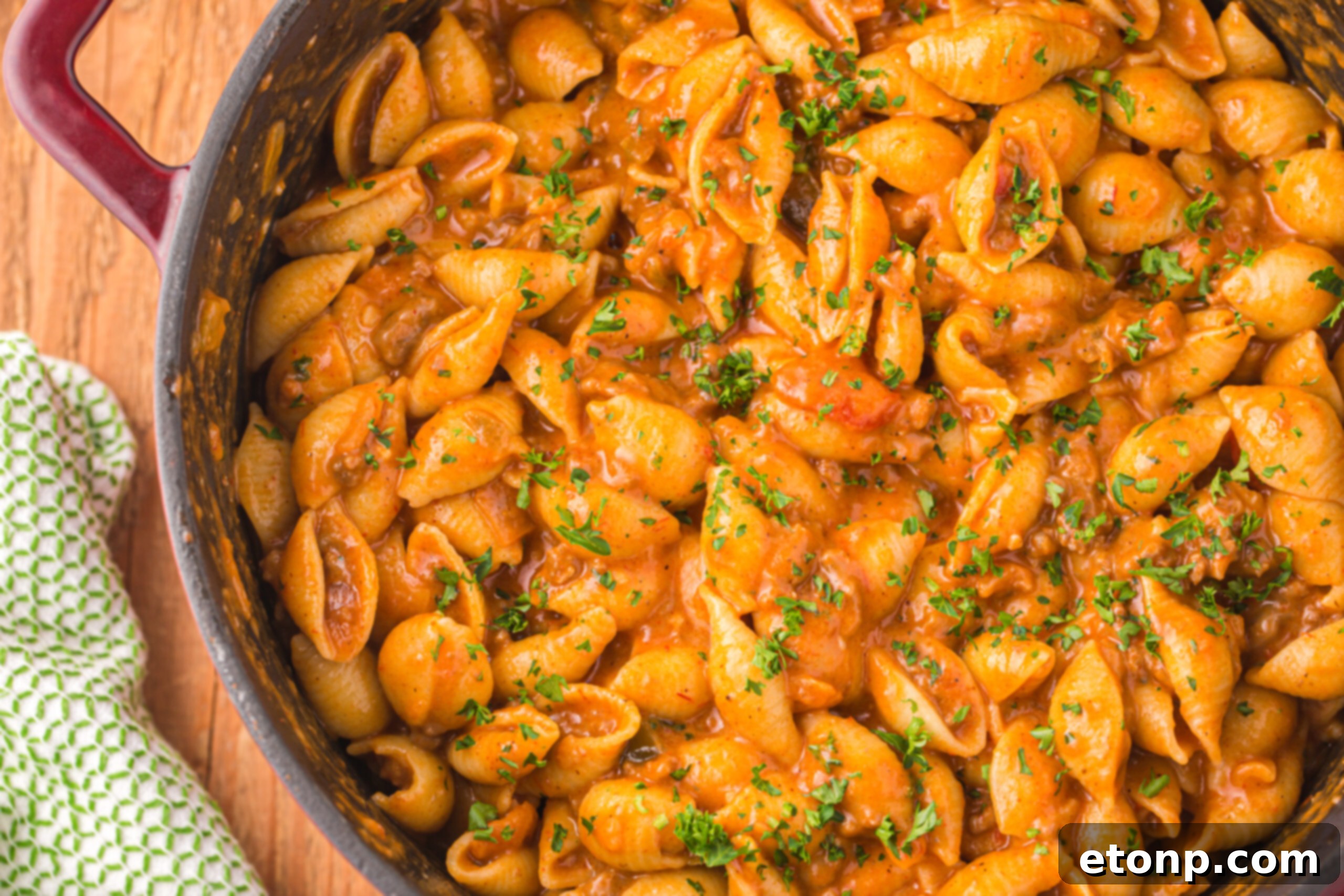 Cheesy Taco Pasta 3 Overhead view of a sizzling skillet filled with cheesy taco pasta, highlighting its appetizing blend of pasta, meat, and melted cheese.