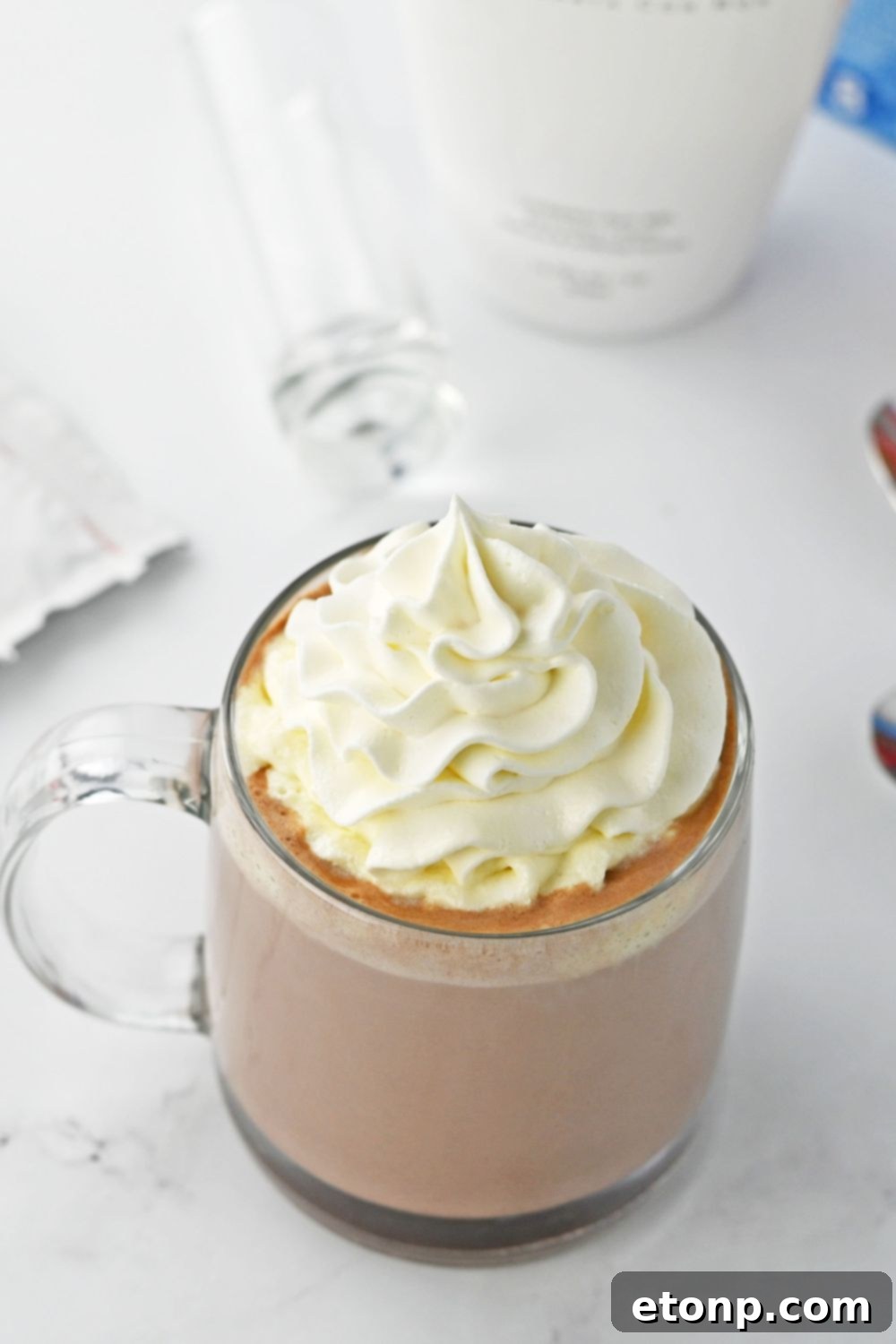 rumchata hot chocolate topped with whipped cream sitting on table