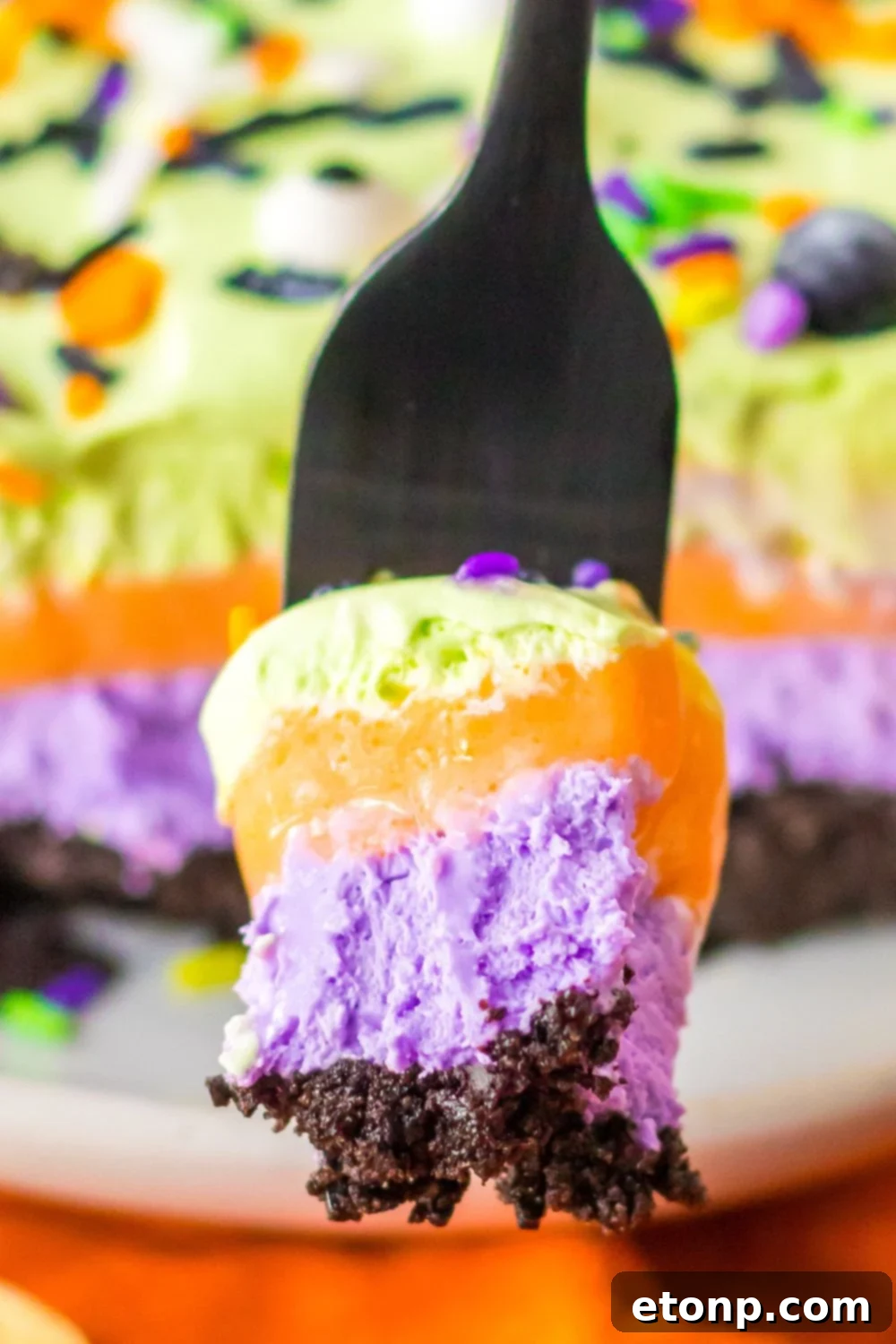 fork with lush layered dessert on it
