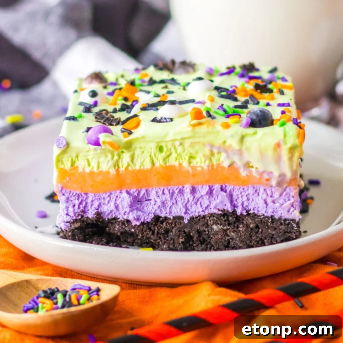 Halloween Lush Dessert sliced and placed on plate with sprinkles in a bowl on side