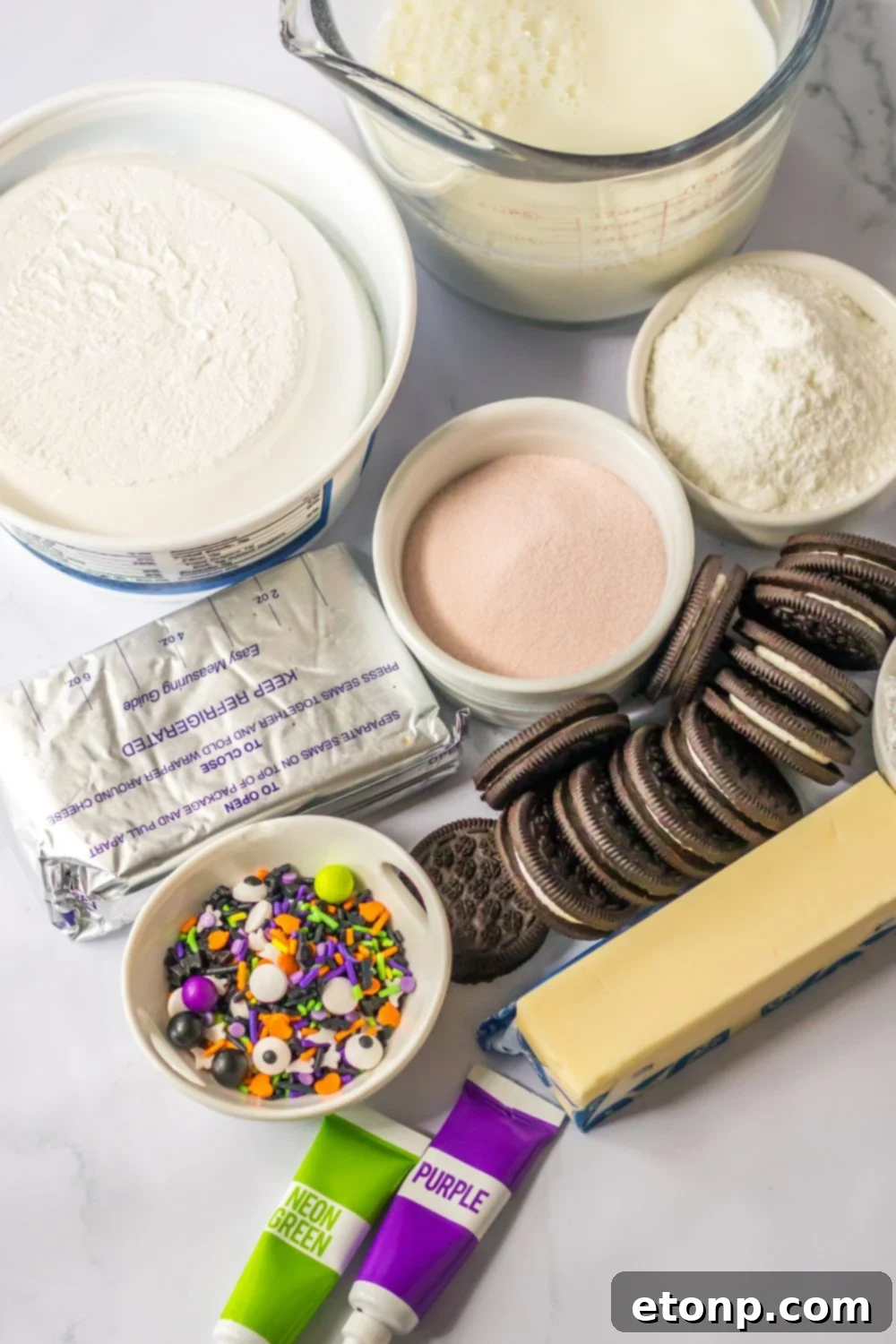 cream cheese layered dessert ingredients on a marble counter