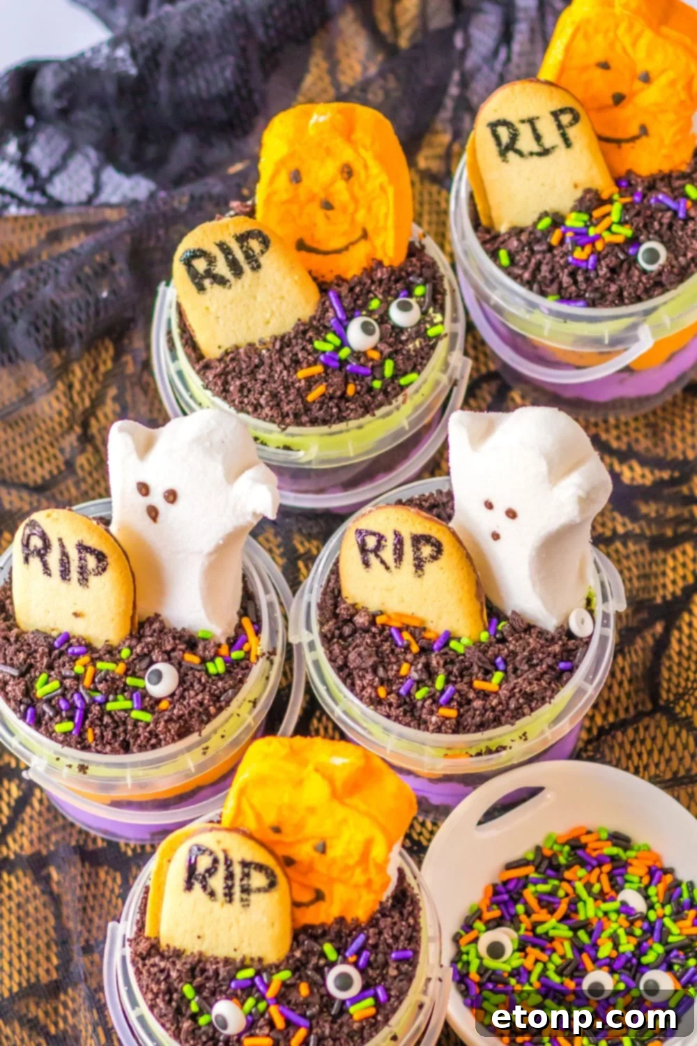 halloween pudding cups in containers on table with a bowl of sprinkles beside it