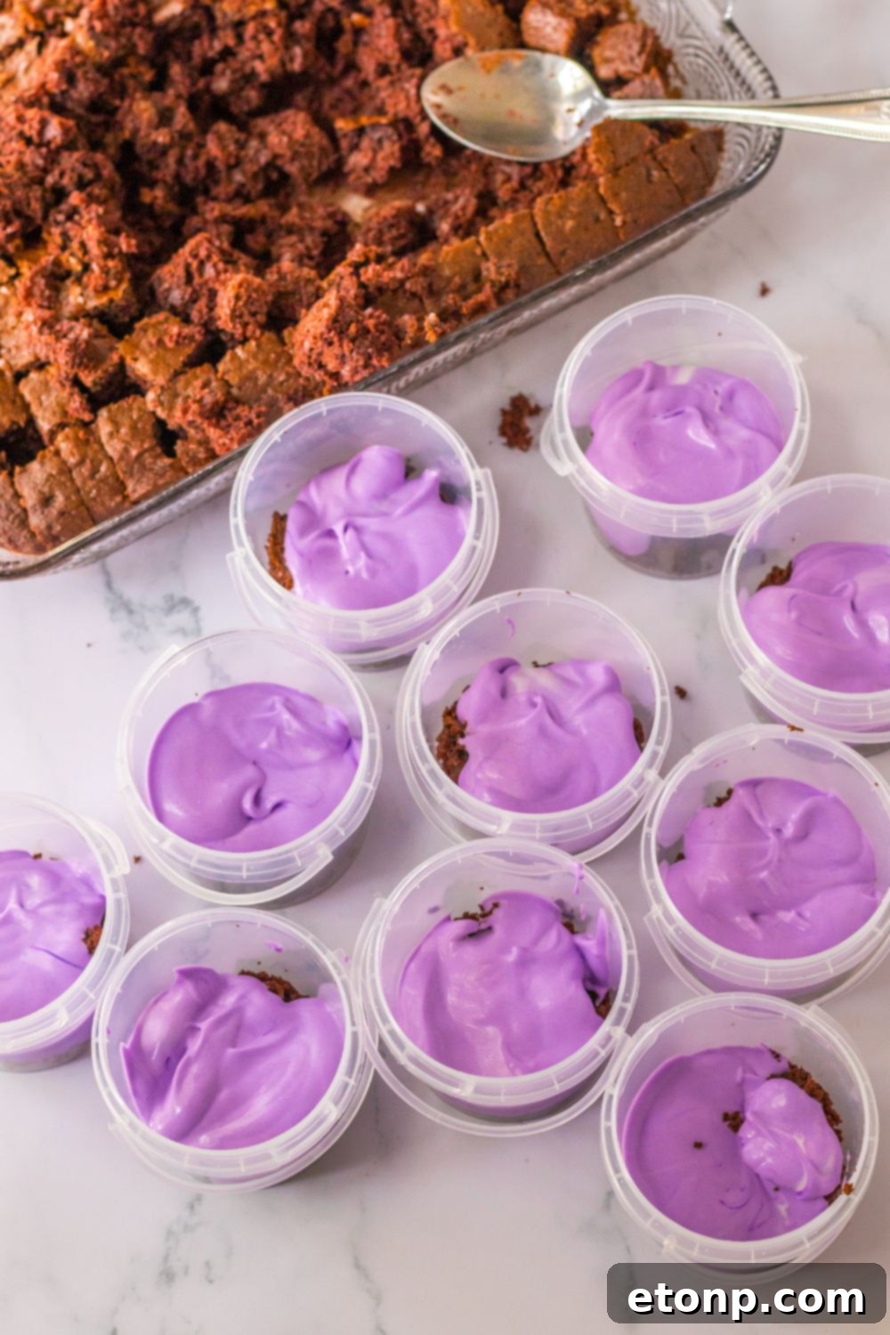 purple pudding in plastic containers on table 