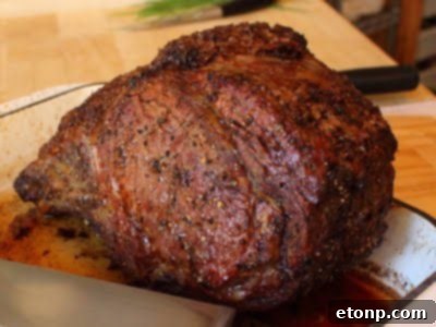 Perfectly cooked Prime Rib Roast with a crusty exterior and tender, juicy interior.