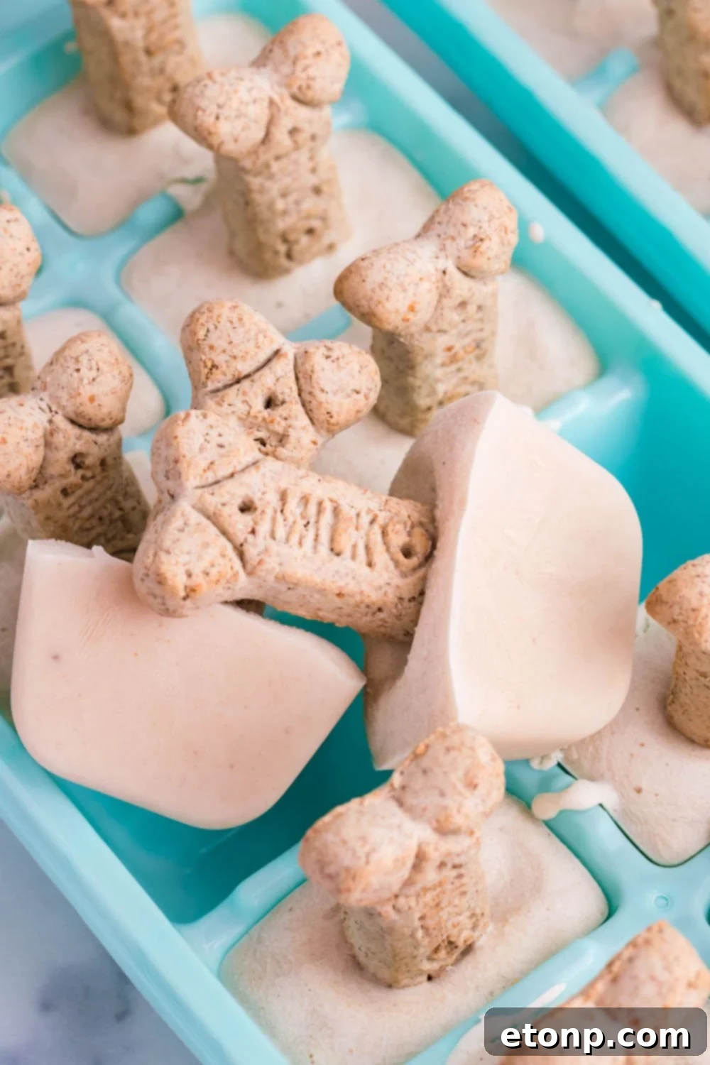 ice cream in a ice cube tray with cookie on it