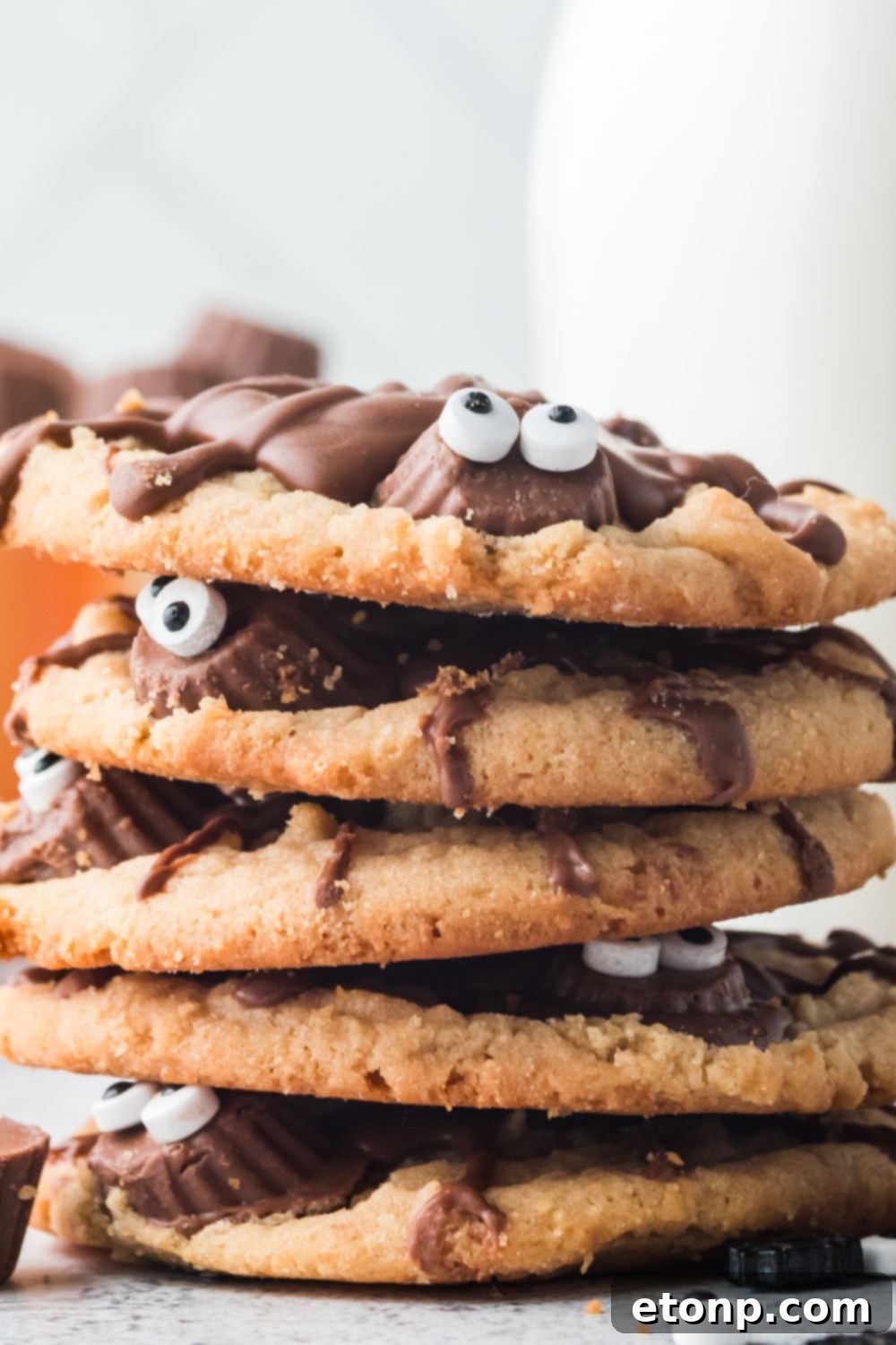 Frightfully Delicious Peanut Butter Spider Cookies 14 halloween cookies stacked on top of each other on table