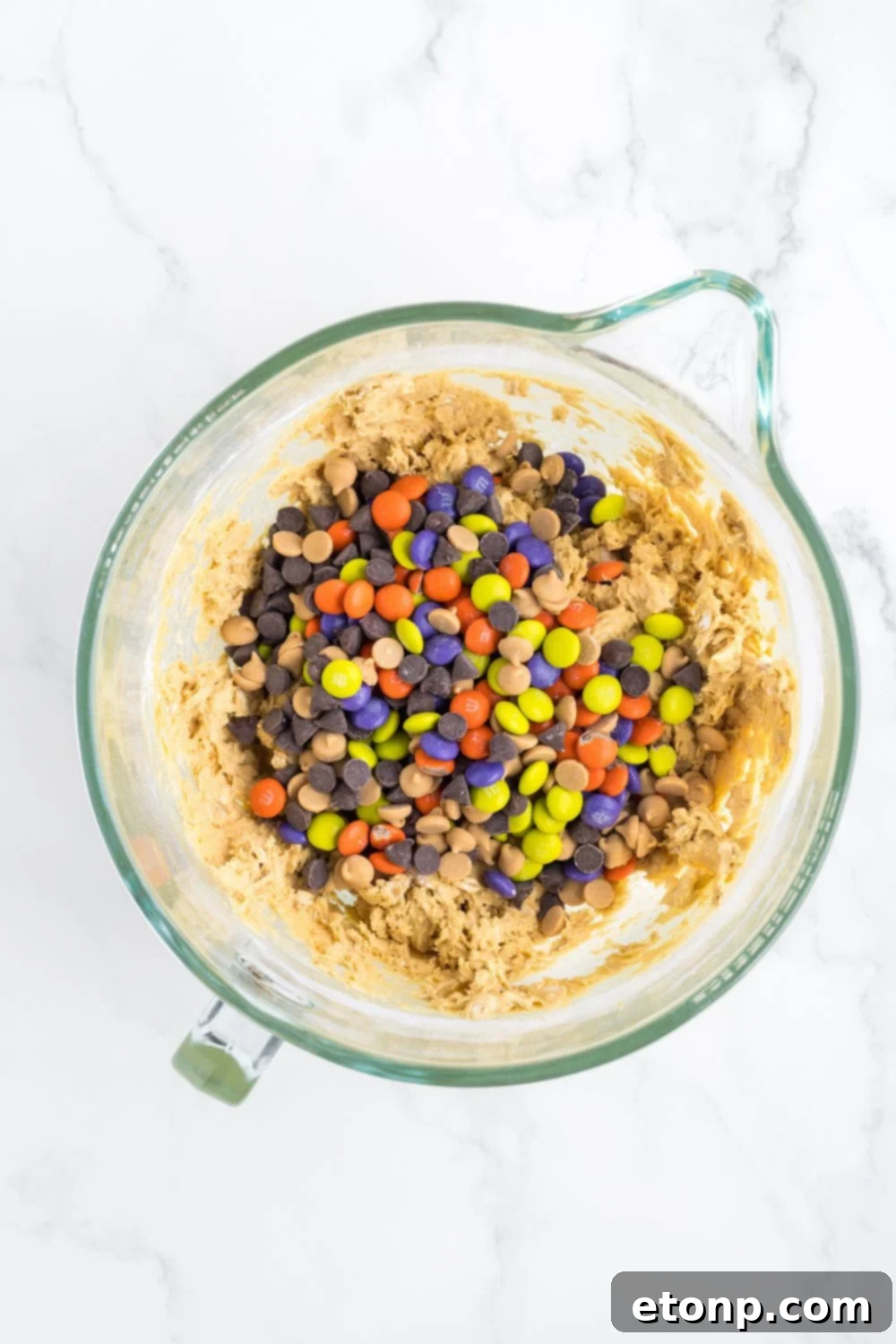 mixing cup with cookie dough and m&ms in it