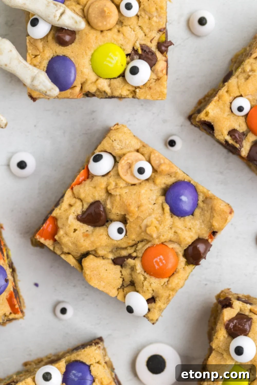 sliced cookie bars on table with candy eyes around it for Halloween