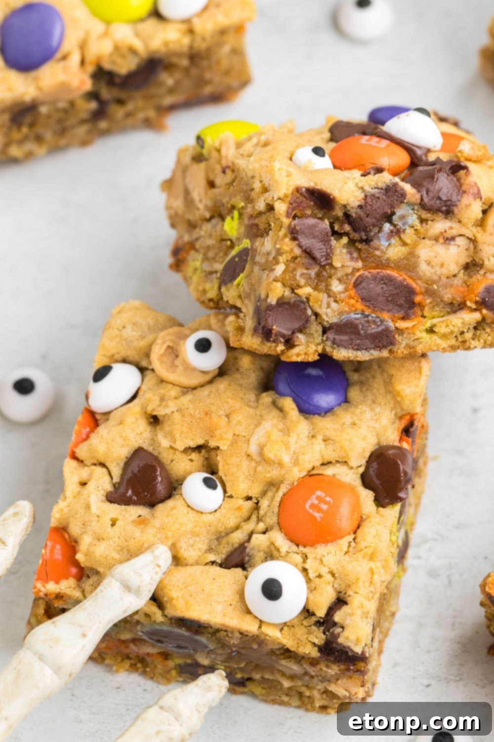 cookie bars on table with a skeleton halloween decoration by it