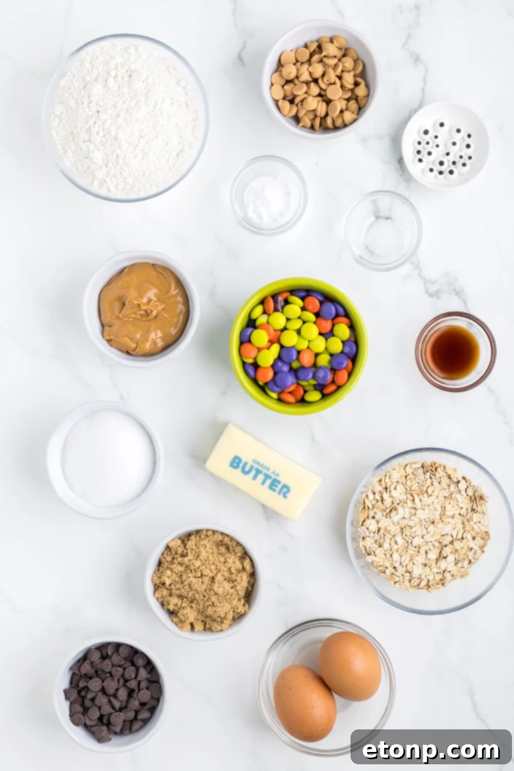 ingredients for monster cookie bars on table in glass bowls