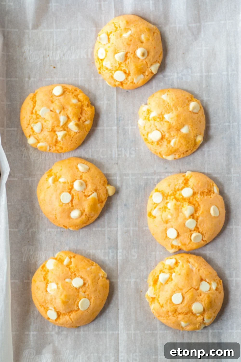 overhead shot of cooked orange cookies on a baking sheet