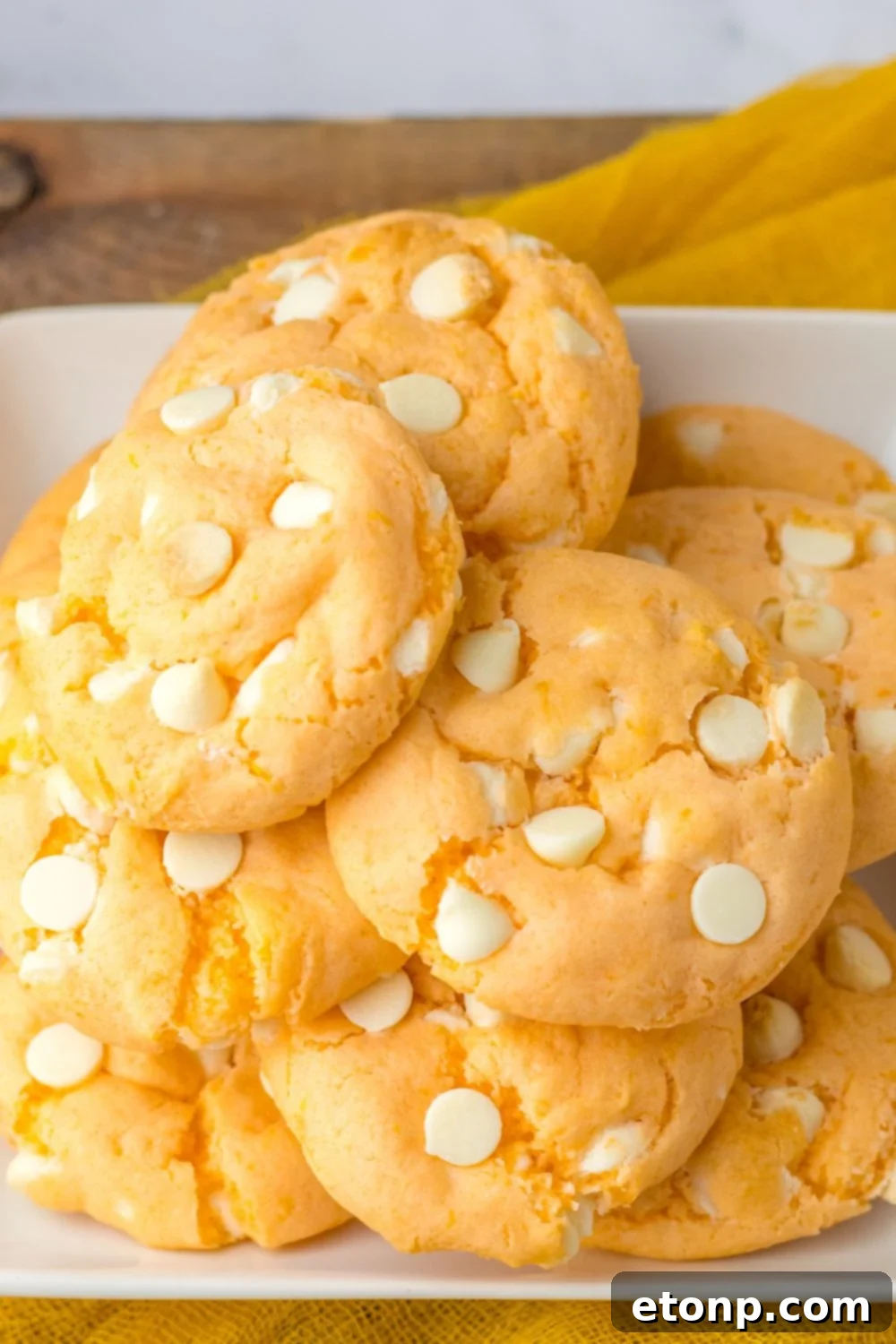 orange cookies on a tray stacked on top of each other