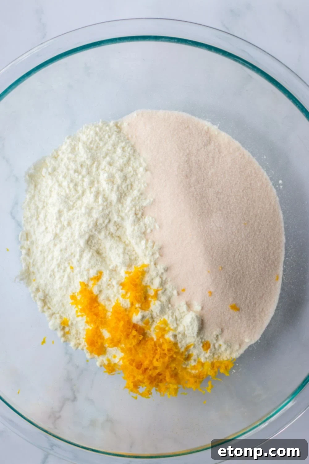 cake mix, orange zest and jello in a glass bowl