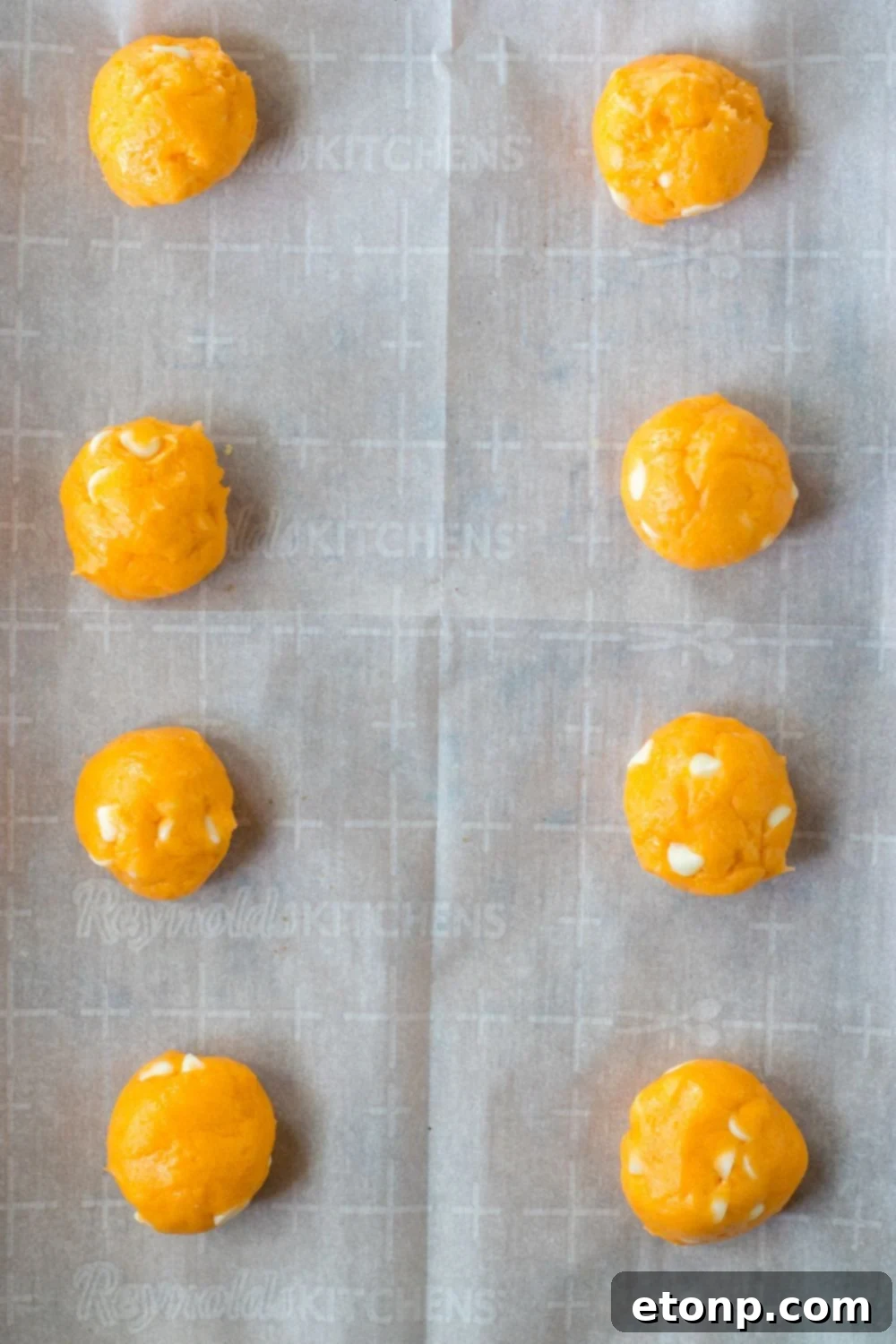 Orange Creamsicle Cookies rolled in balls on baking sheet 