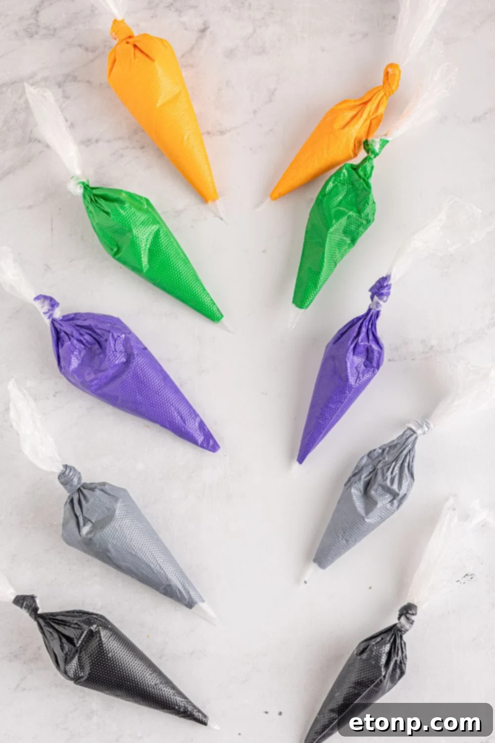 royal icing in piping bags on table 