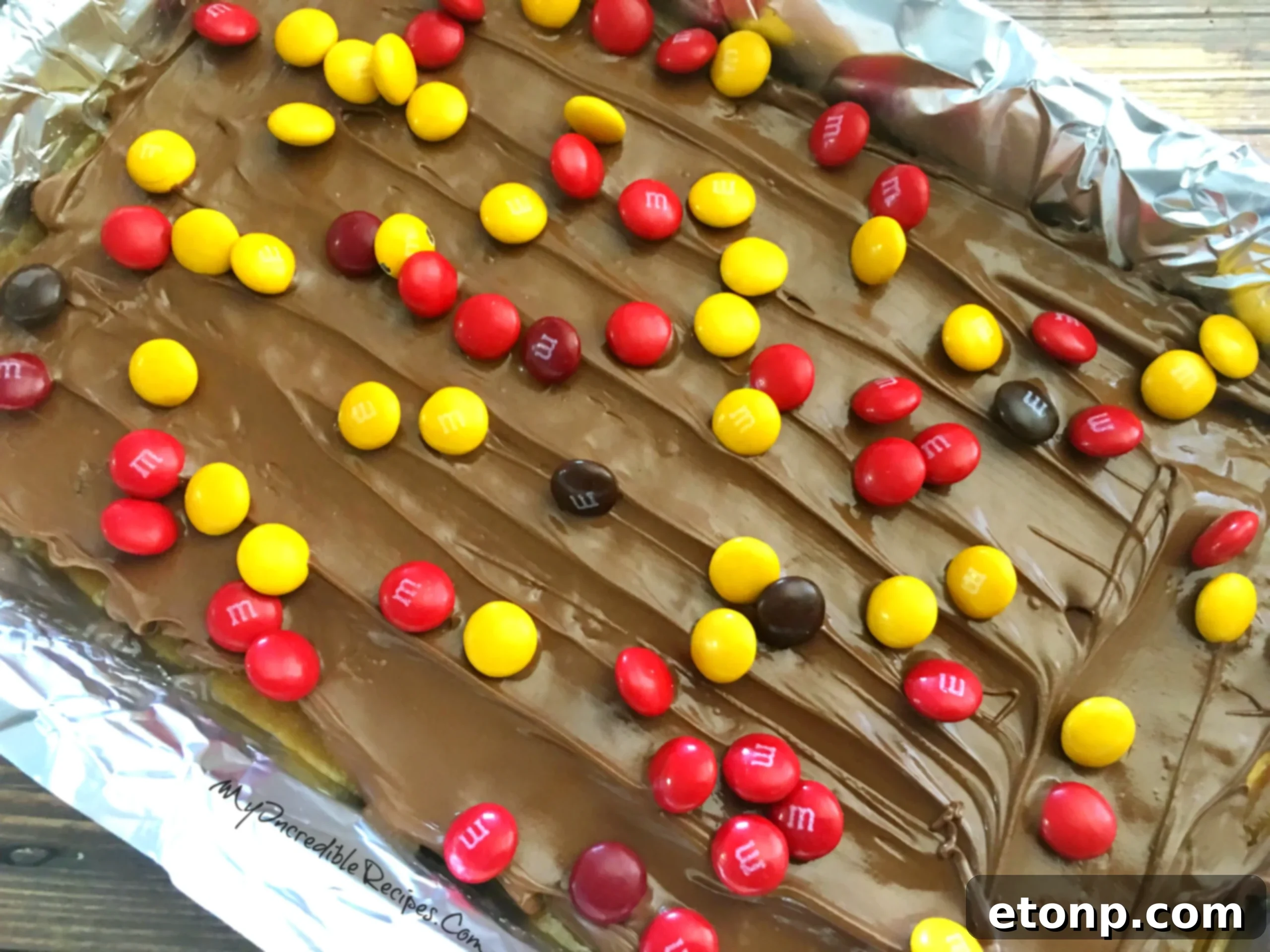 M&Ms and other toppings generously covering the chocolate layer of the toffee crack