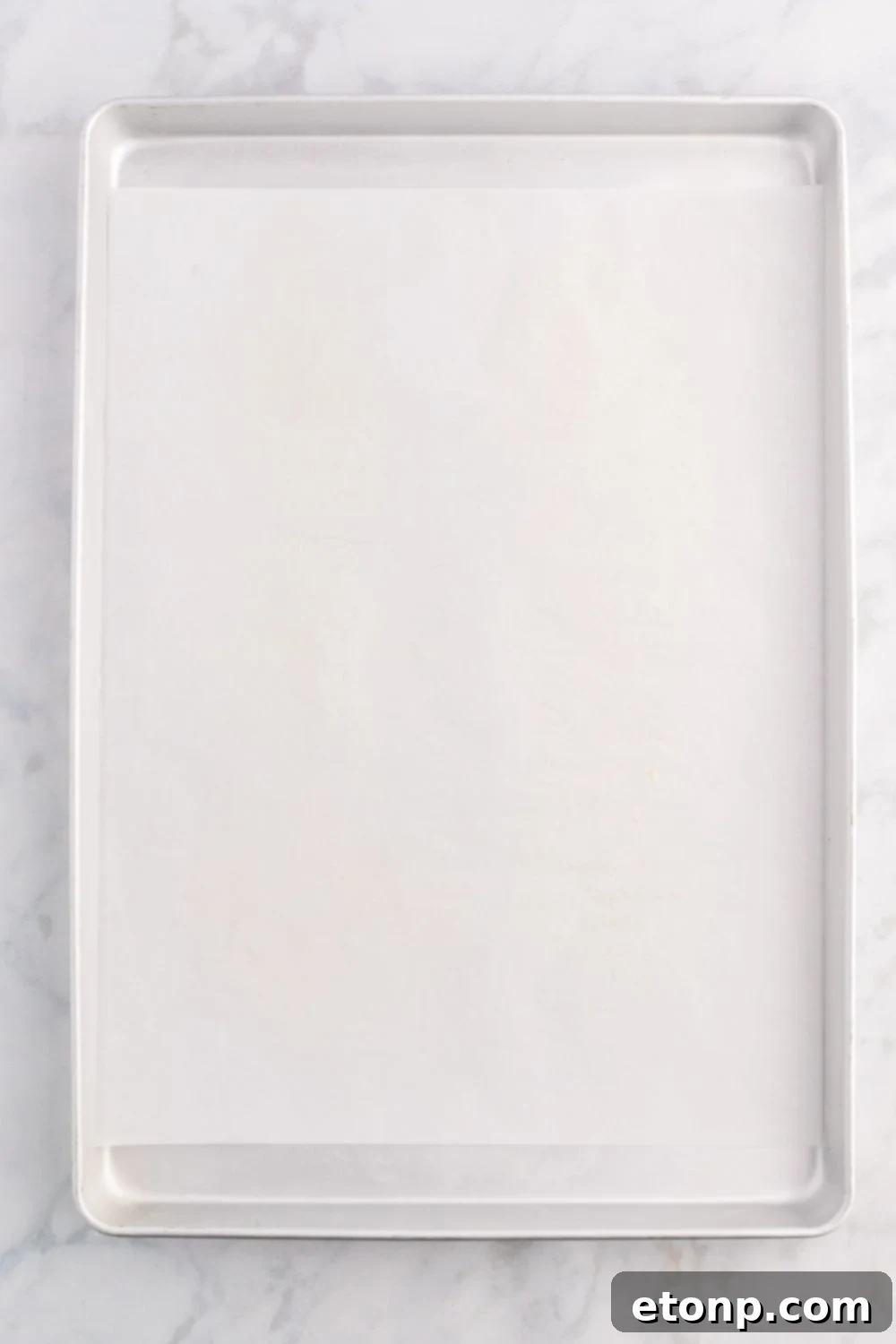sheet pan with parchment paper on it 
