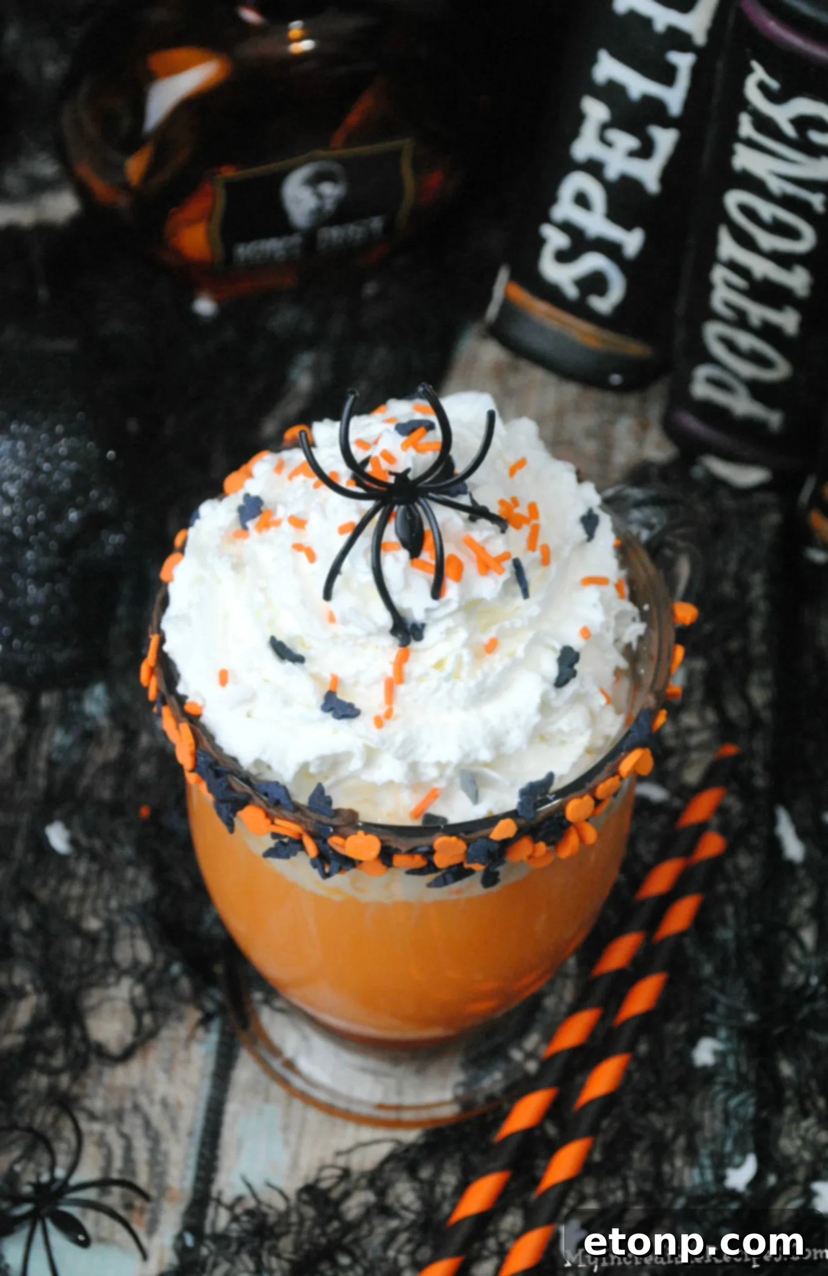 The Ultimate Slow Cooker Halloween Hot Chocolate 4 Close-up of creamy white hot chocolate with Halloween sprinkles