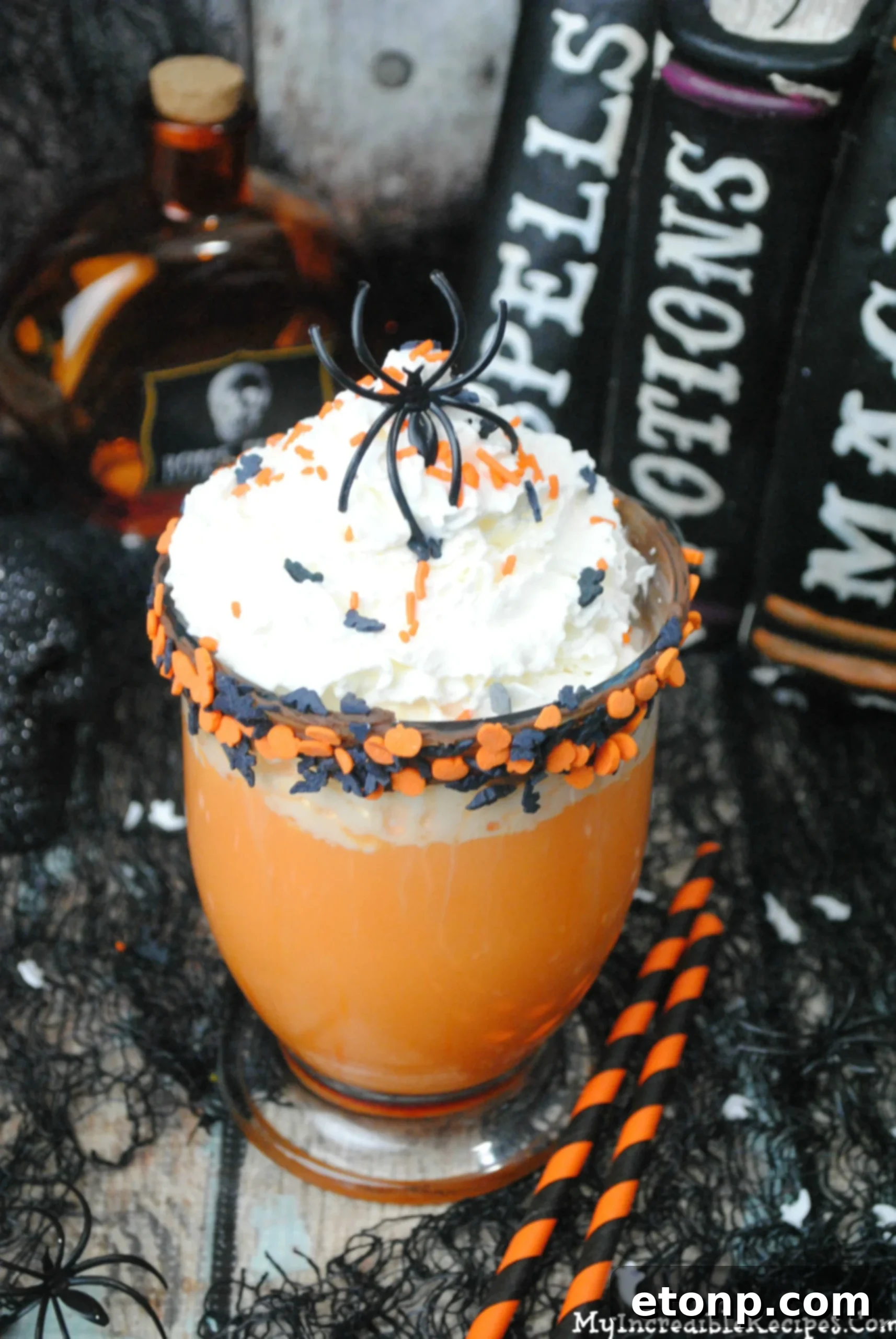 The Ultimate Slow Cooker Halloween Hot Chocolate 6 Mug of hot chocolate decorated with Halloween-themed sprinkles