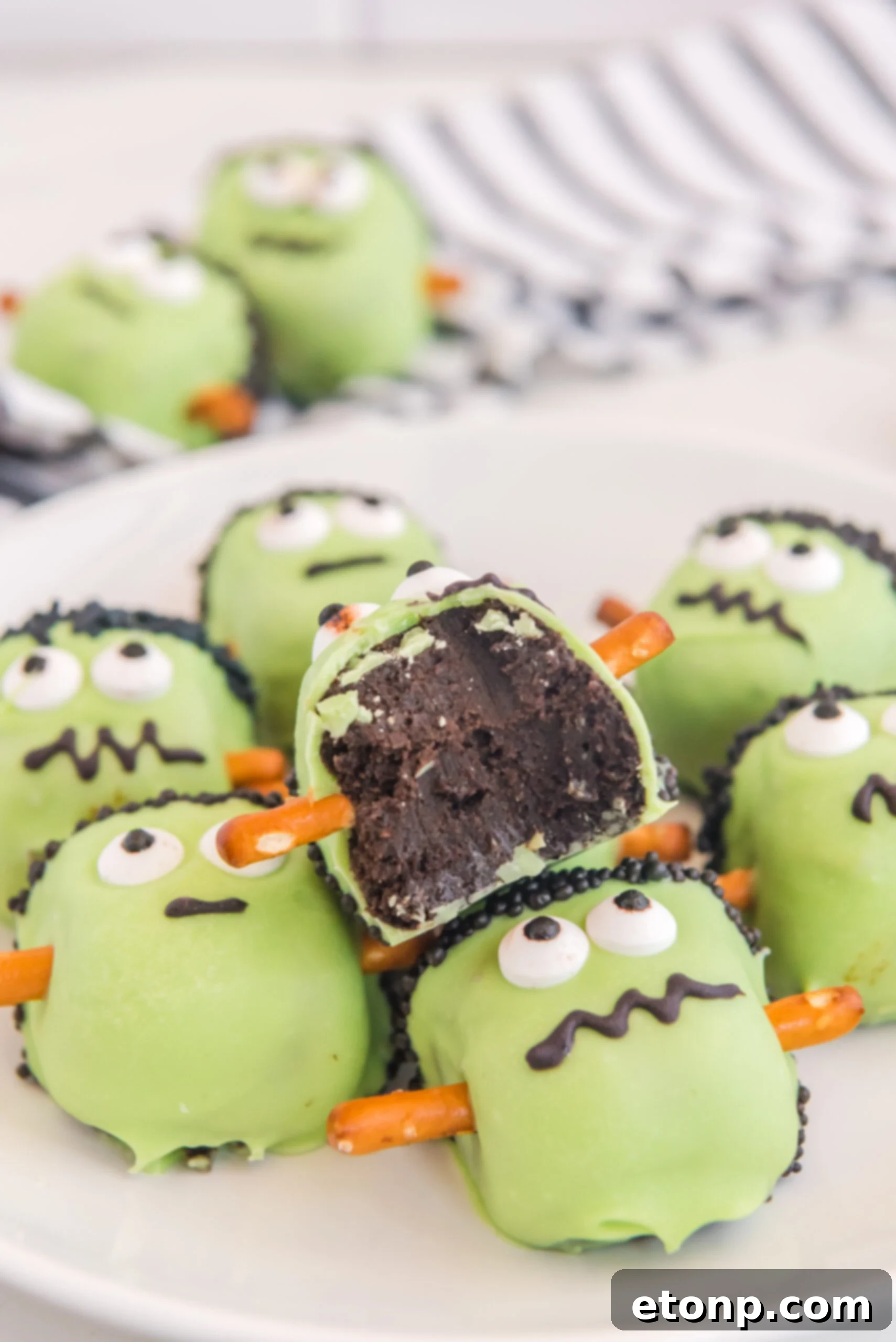 a pile of the Frankenstein Oreo balls with a bite taken out of the top one