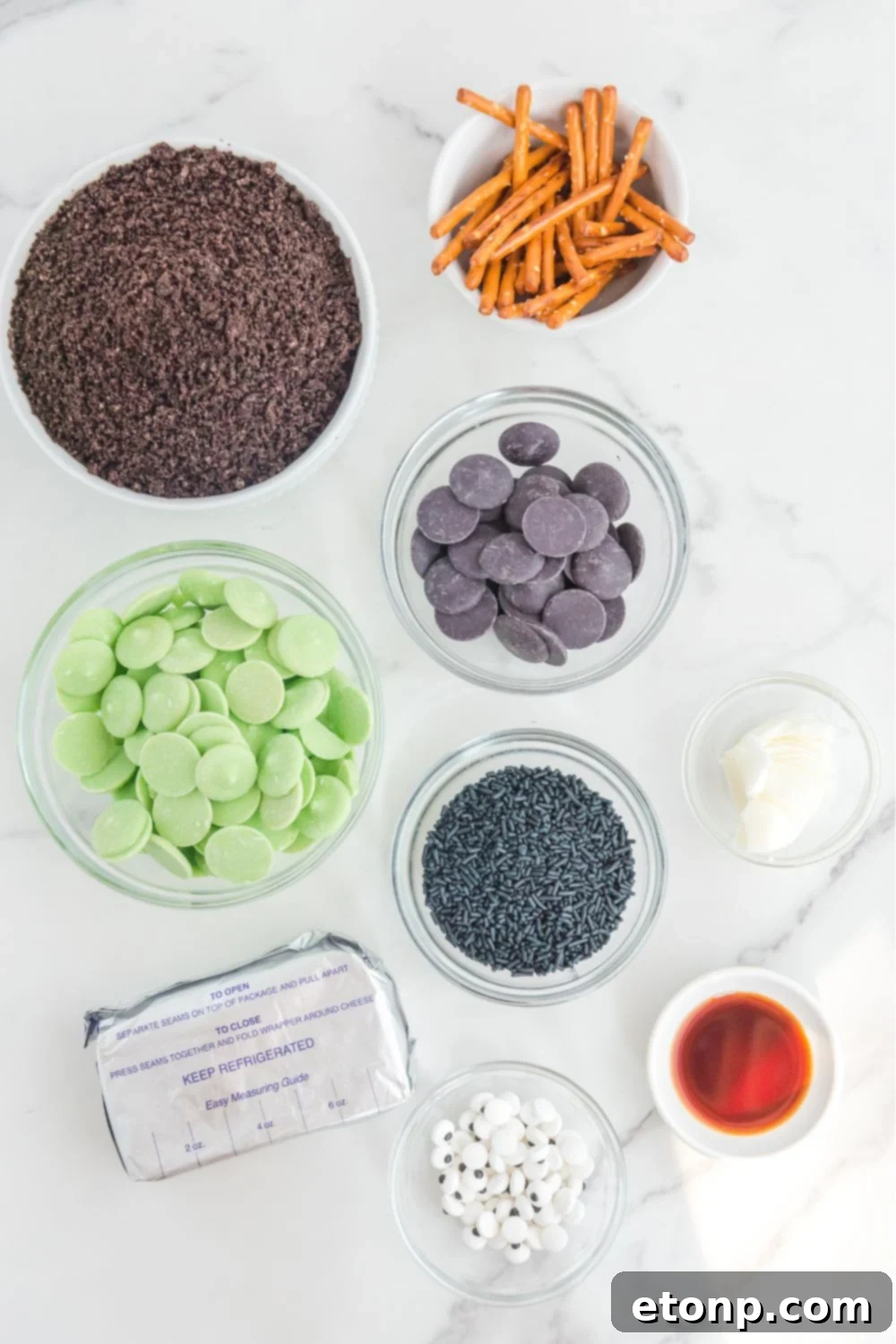 Frankenstein Oreo Balls ingredients on glass containers on a marble counter 