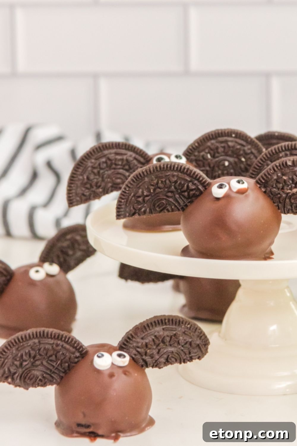 Bat Oreo Truffles on a table and a serving tray, ready for a party