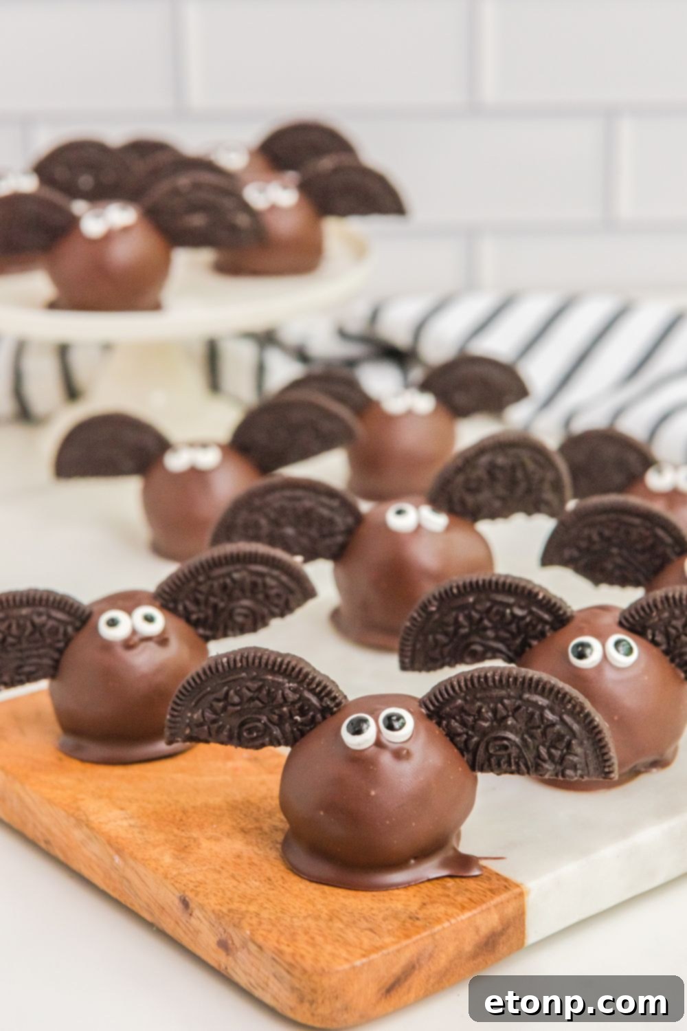 Halloween themed truffles, including Bat Oreo Truffles, arranged artistically on a table