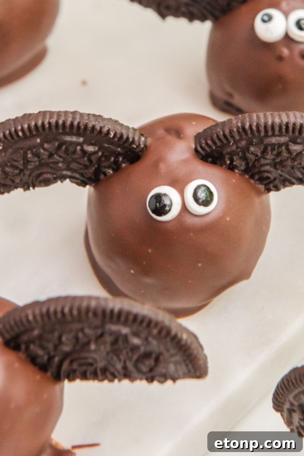 An assortment of spooky Halloween treats on a table, highlighting the Bat Oreo Truffles