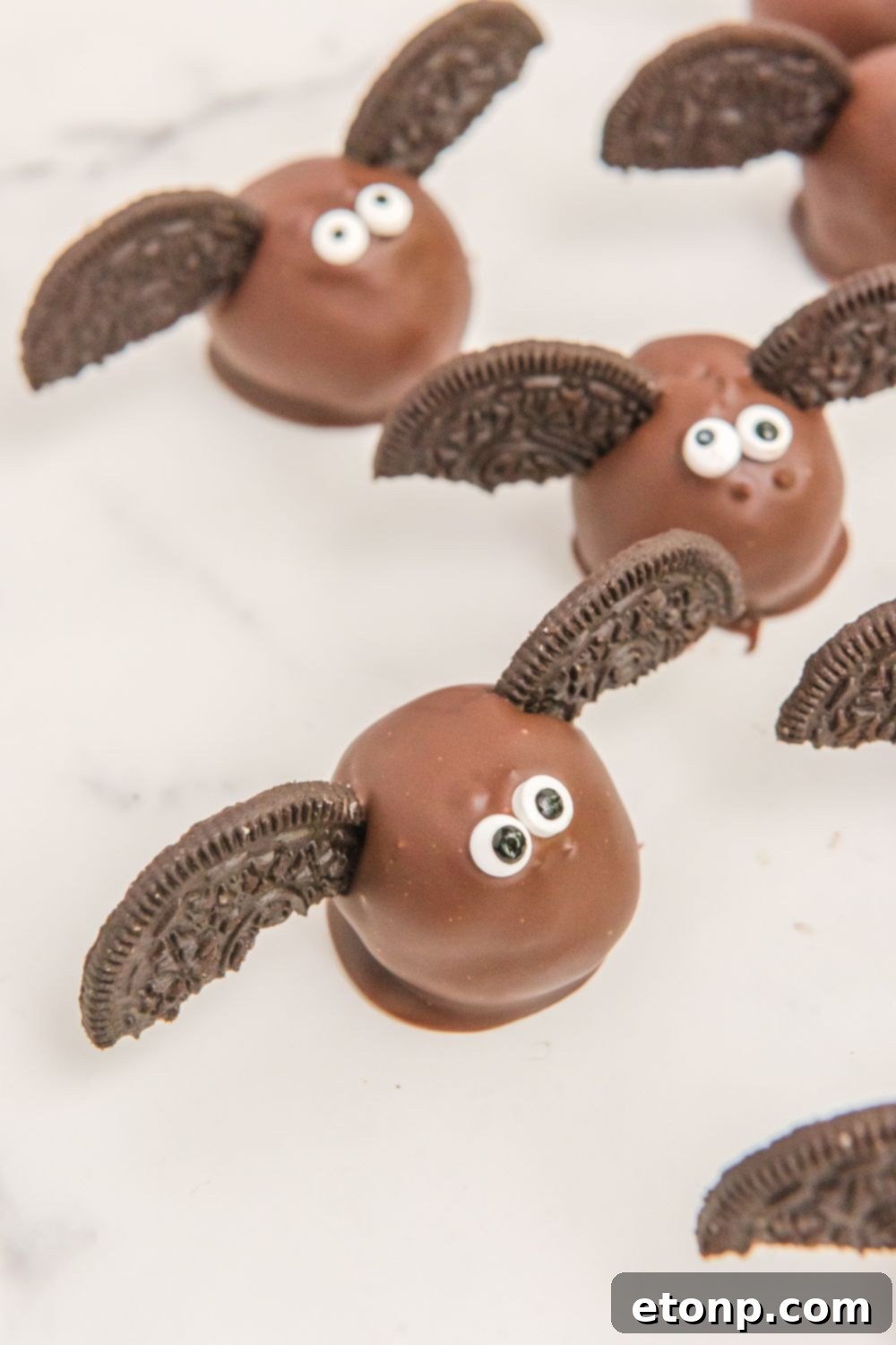 A festive display of Oreo balls and other Halloween treats on a decorated table