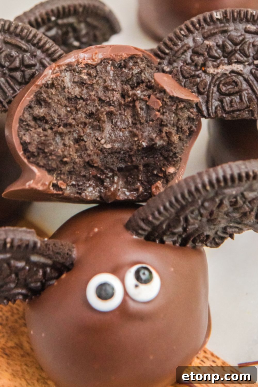 A Bat Oreo Truffle with a bite taken out, revealing the creamy Oreo center