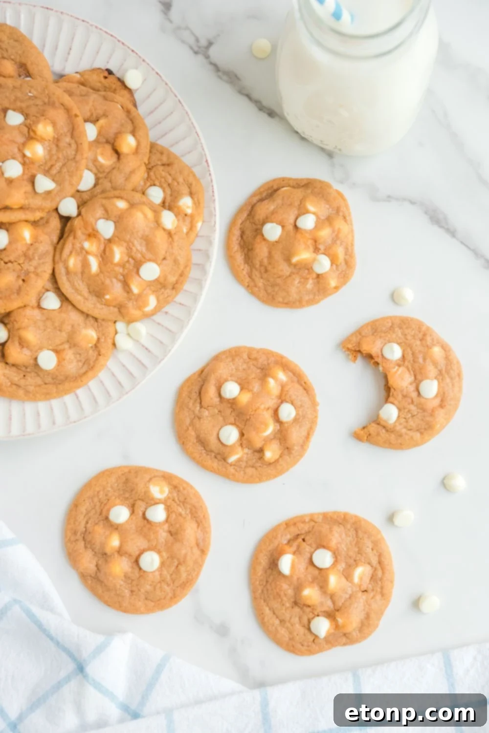 cookies on table with one cookie with a bite taken out