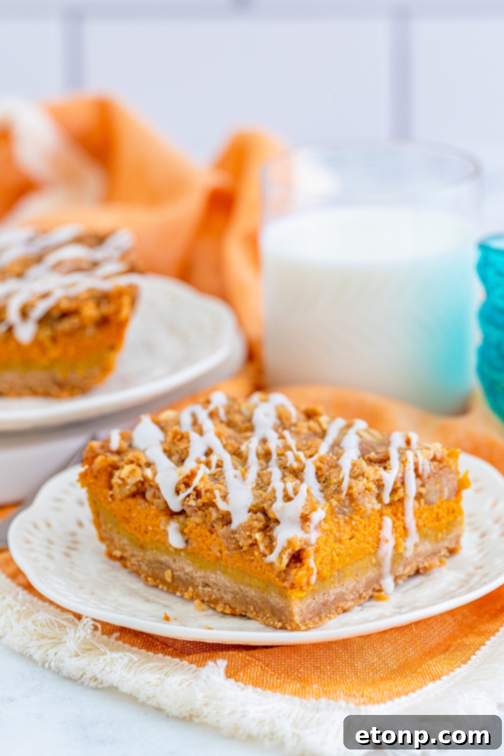 Sweet Autumn Pumpkin Crumble Bars 2 Pumpkin Streusel Bars on a white plate with a glass of milk next to it