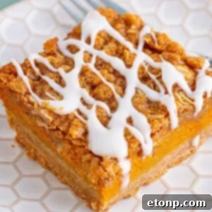 Sweet Autumn Pumpkin Crumble Bars 21 Pumpkin Streusel Bar sliced on a white plate