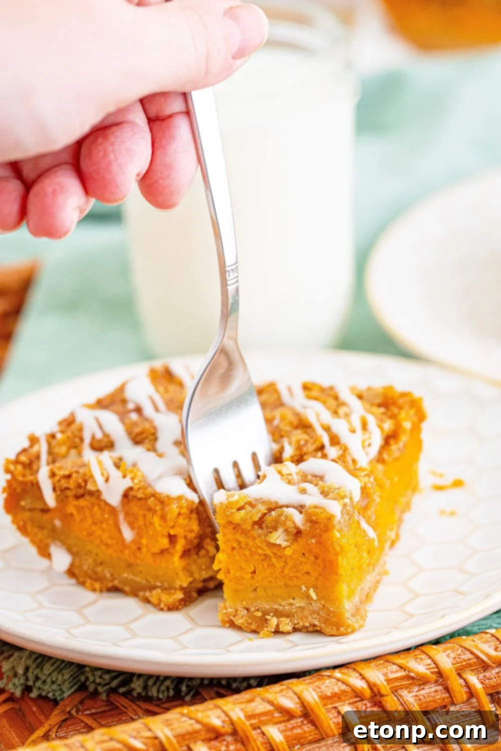 Sweet Autumn Pumpkin Crumble Bars 4 fork poking into a sliced pumpkin streusel bar