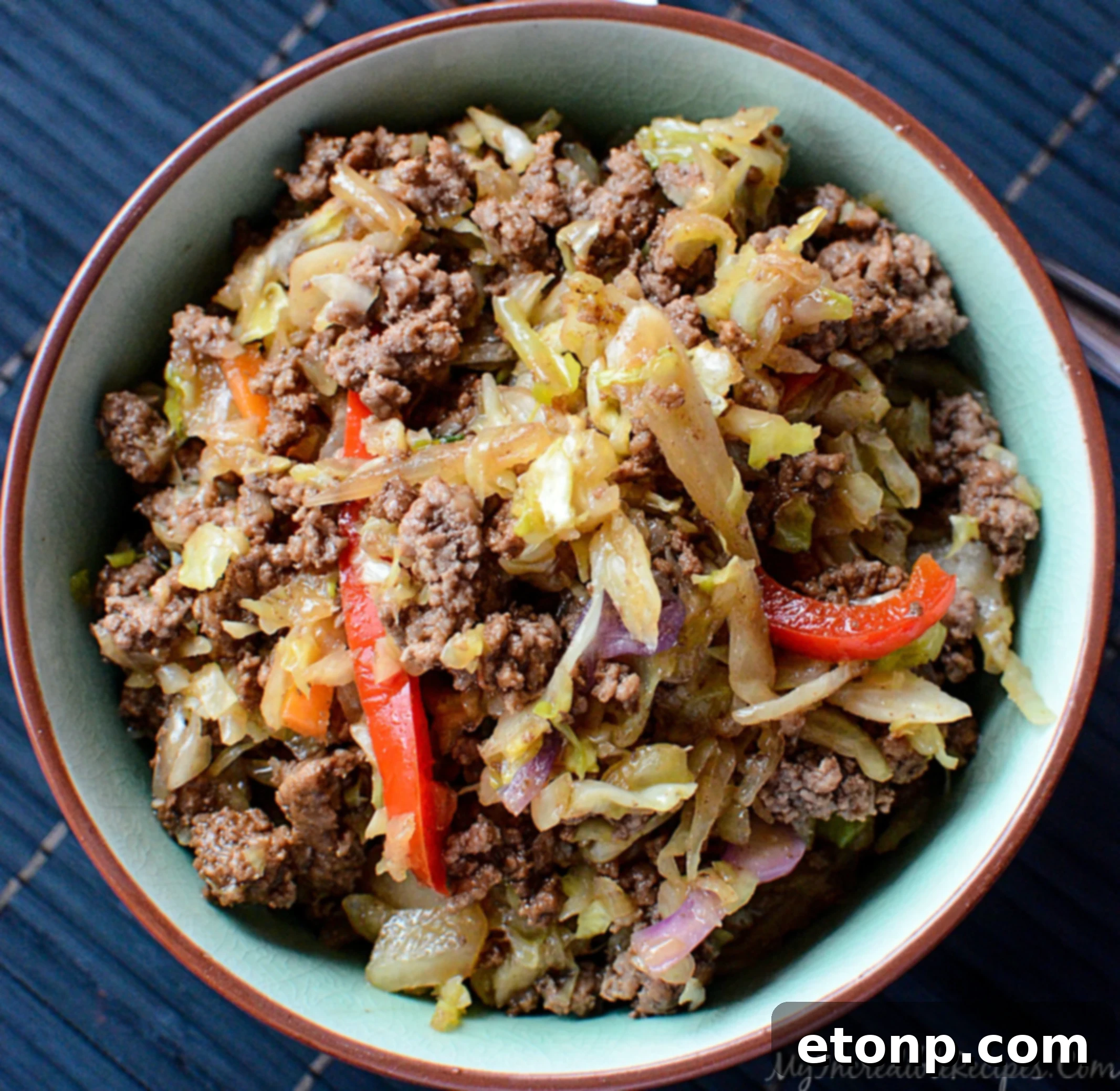 Asian beef and cabbage stir fry served over fluffy white rice