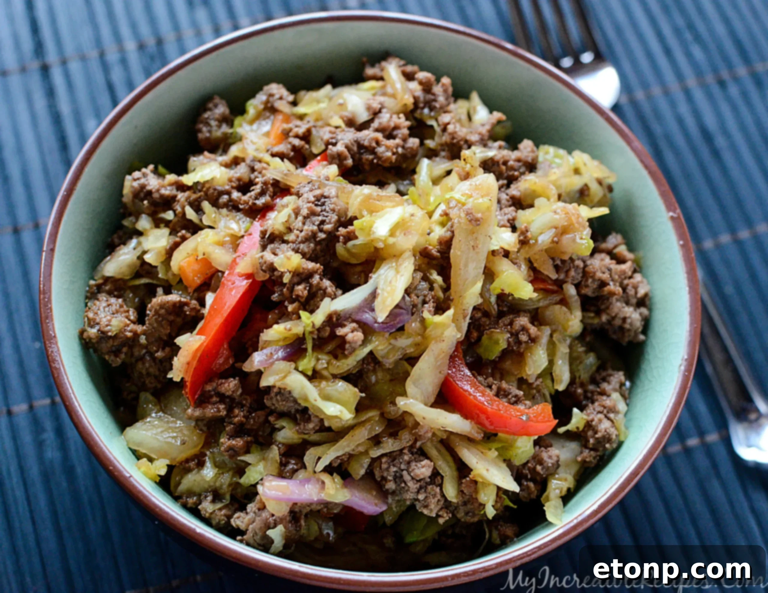 Fresh ingredients for stir fry including cabbage, bell pepper, and beef