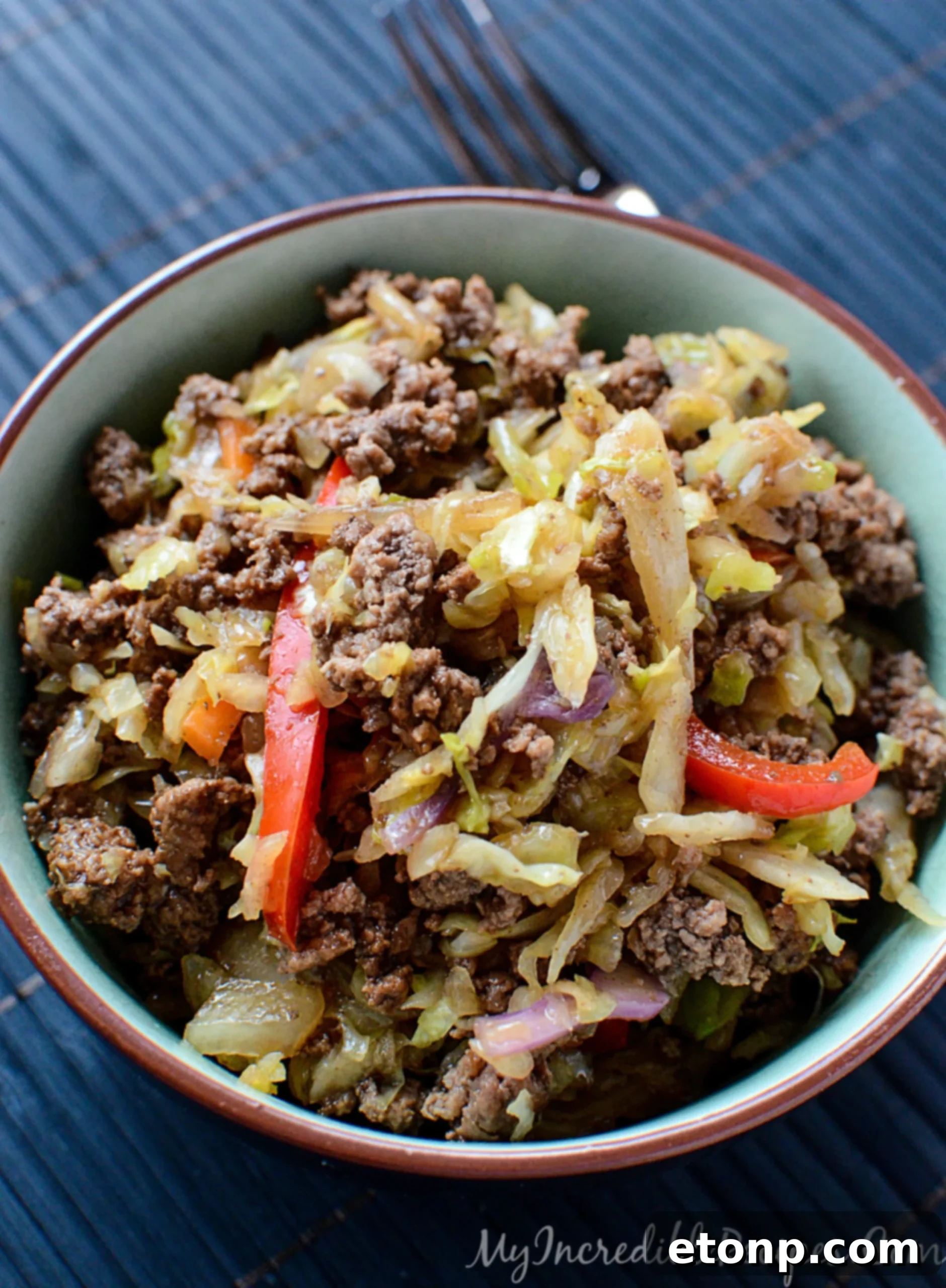 A spoonful of the savory beef and cabbage stir fry