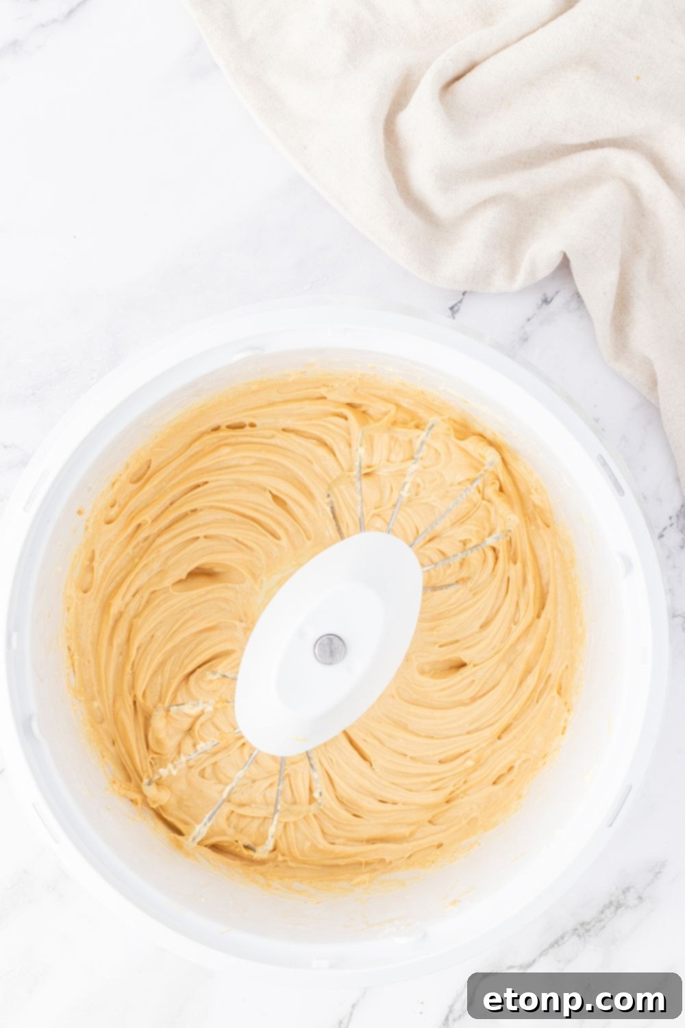 Bite-Sized Peanut Butter Cheesecakes 8 mixer with peanut butter cheesecake filling, step 3