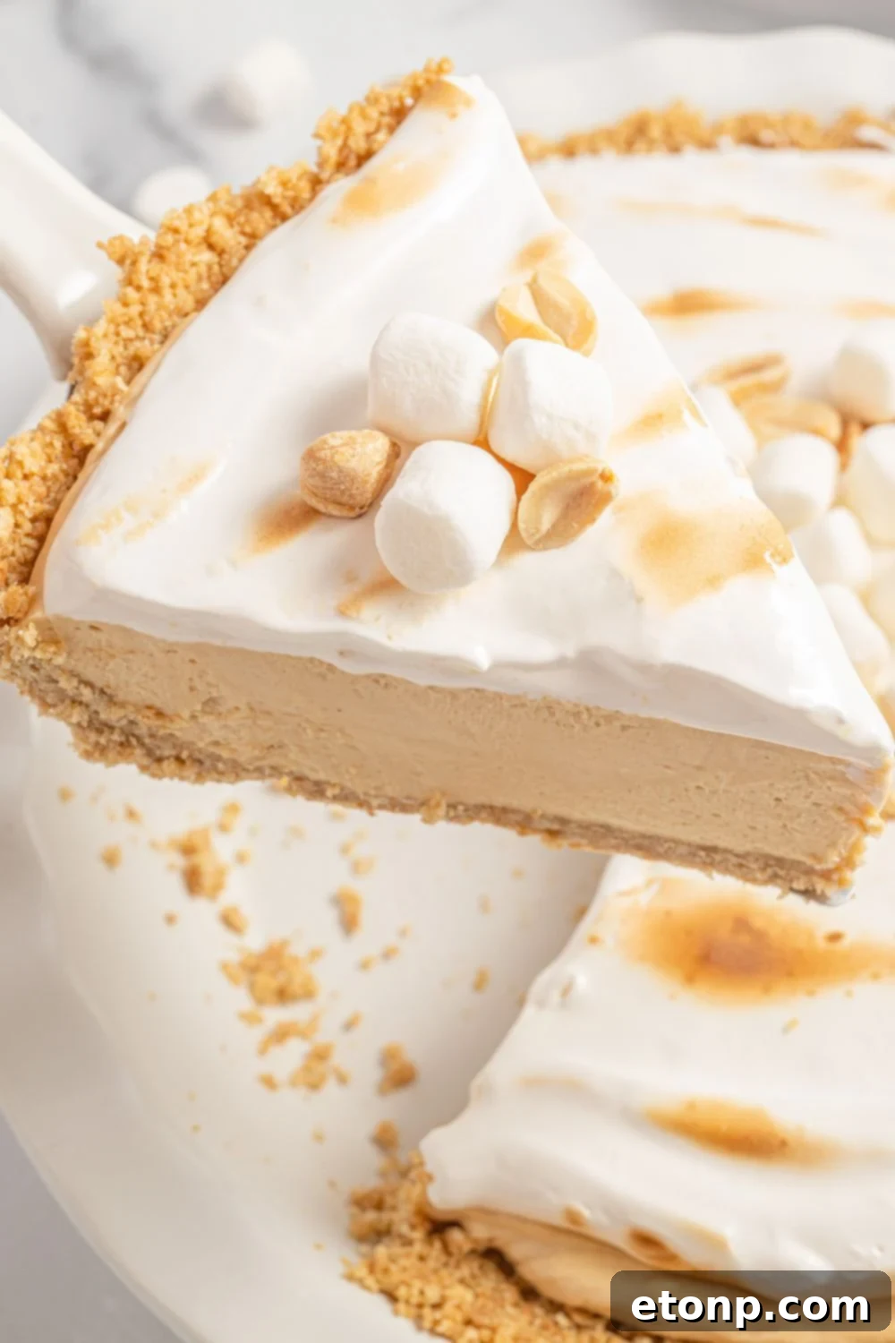 A slice of Fluffernutter Pie being gently lifted from the pan
