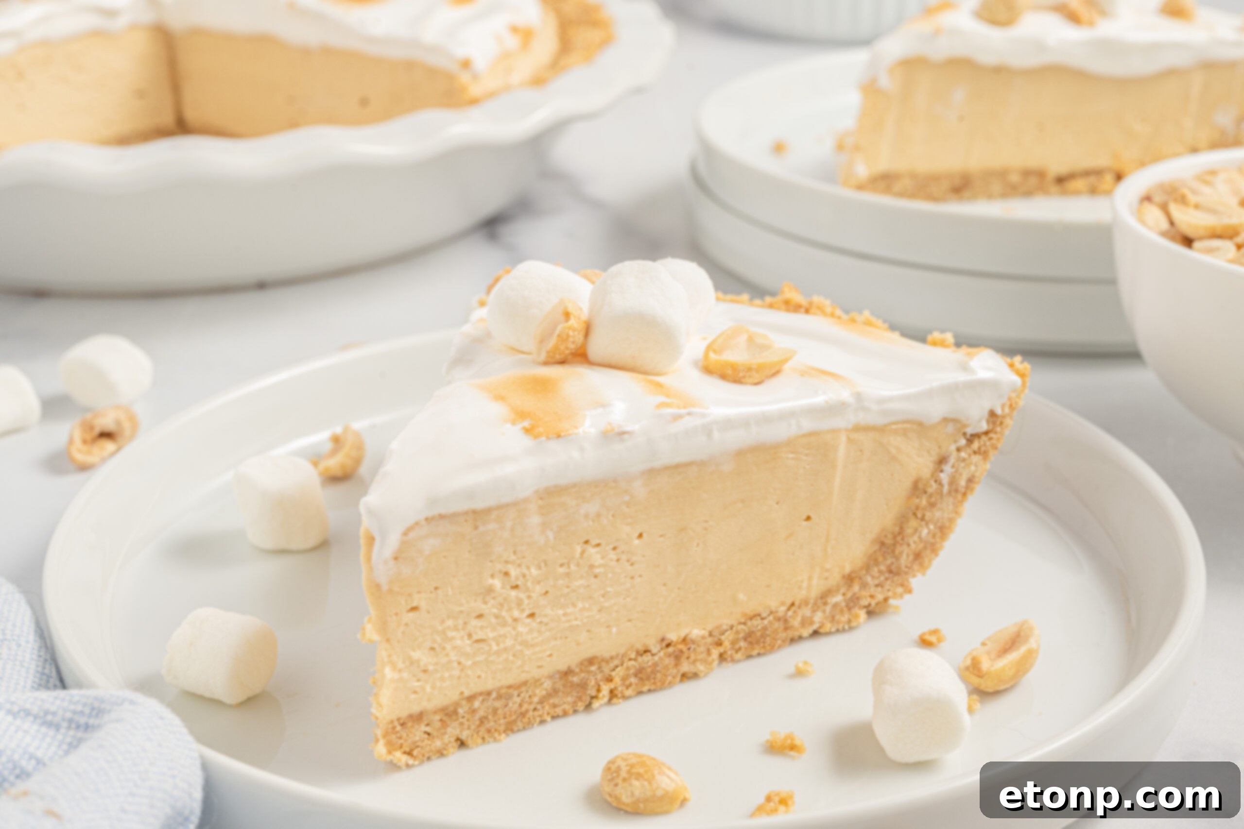 A beautiful slice of Fluffernutter Pie on a white plate, ready to be enjoyed