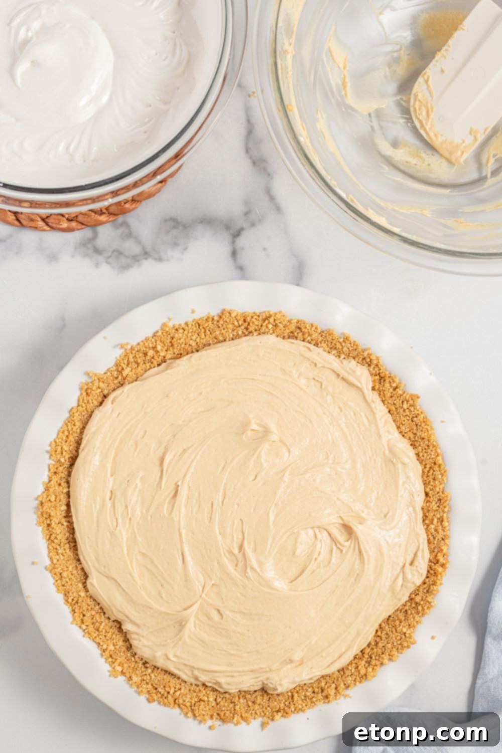 Peanut butter pie filling spread evenly in the graham cracker crust