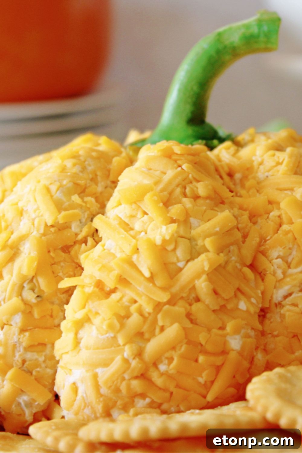 pumpkin shaped cheese ball on a plate