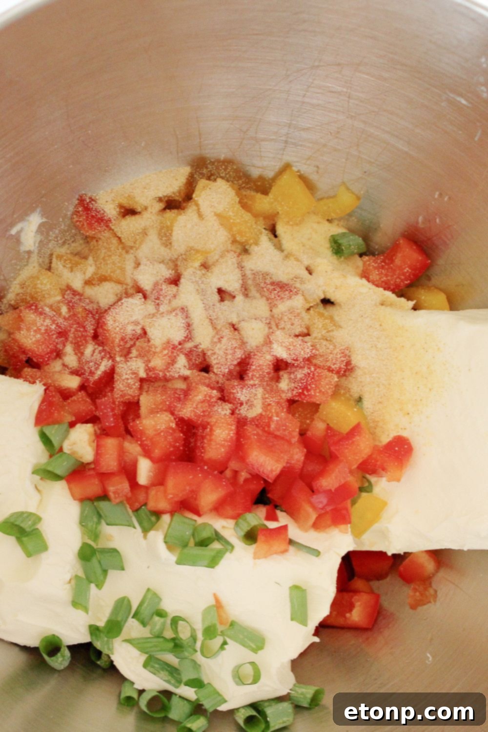 cream cheese mixture in a bowl with peppers, onions, ranch seasoning