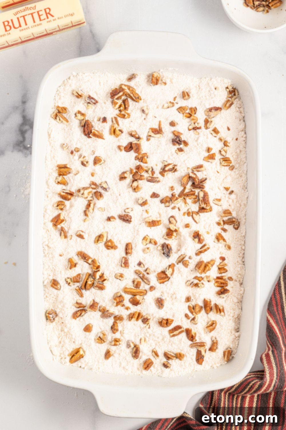 Pumpkin Streusel Cobbler 11 dry cake mix topped with nuts in a 9x13 baking dish