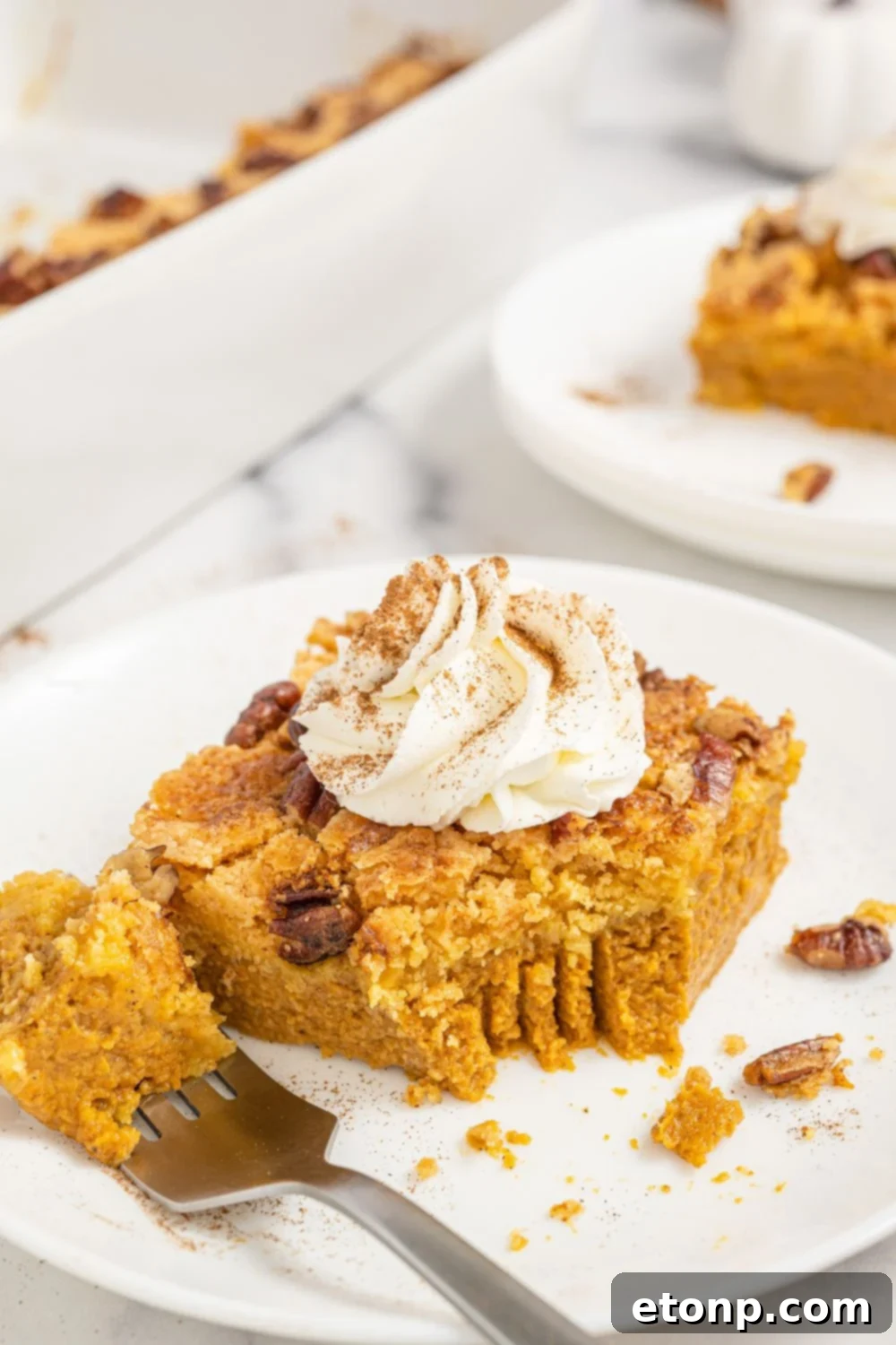 Pumpkin Streusel Cobbler 16 pumpkin cake with a bite taken out of slice sitting on a fork on plate