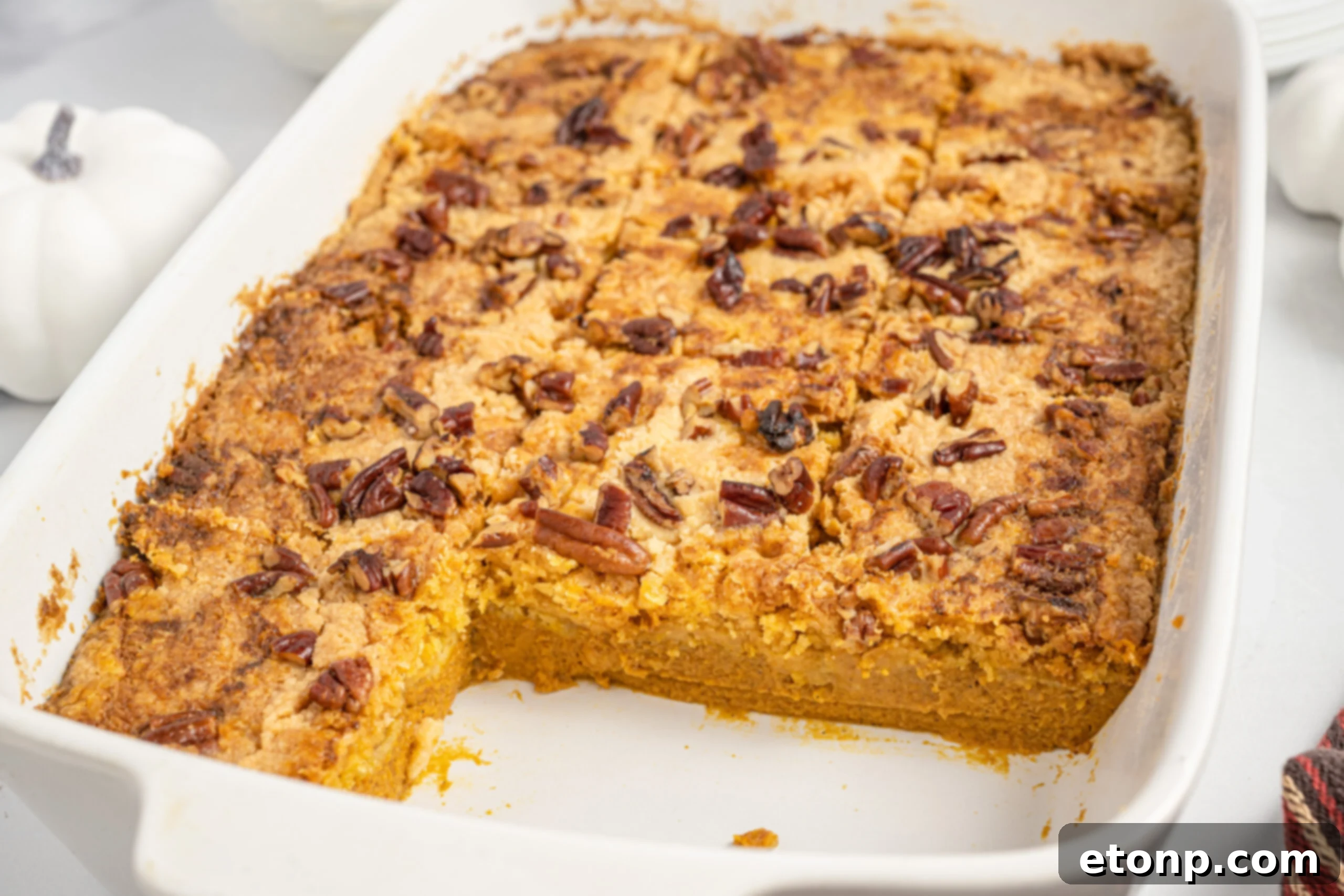 Pumpkin Streusel Cobbler 4 Pumpkin Dump Cake in a white baking dish with slices removed