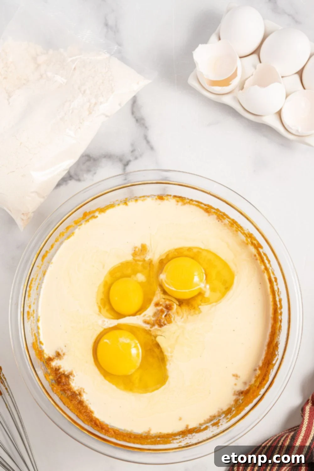 Pumpkin Streusel Cobbler 8 pumpkin cake mixture in bowl with eggs and evaporated milk