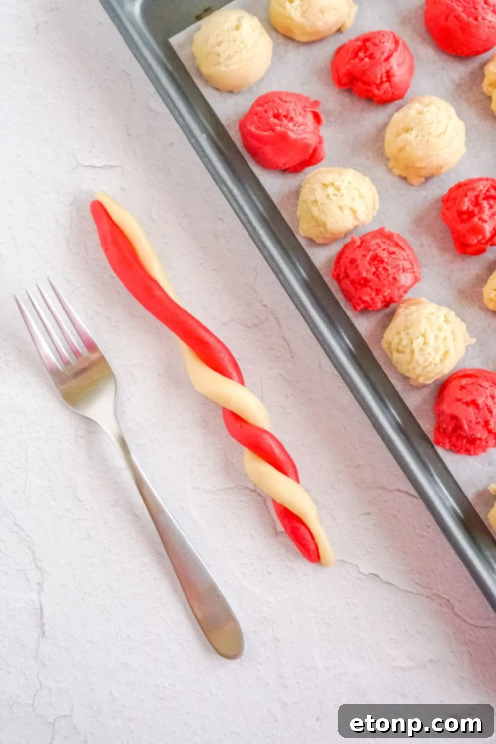 Sweet Peppermint Swirls 11 Twisting cookie dough into candy cane shapes on a table